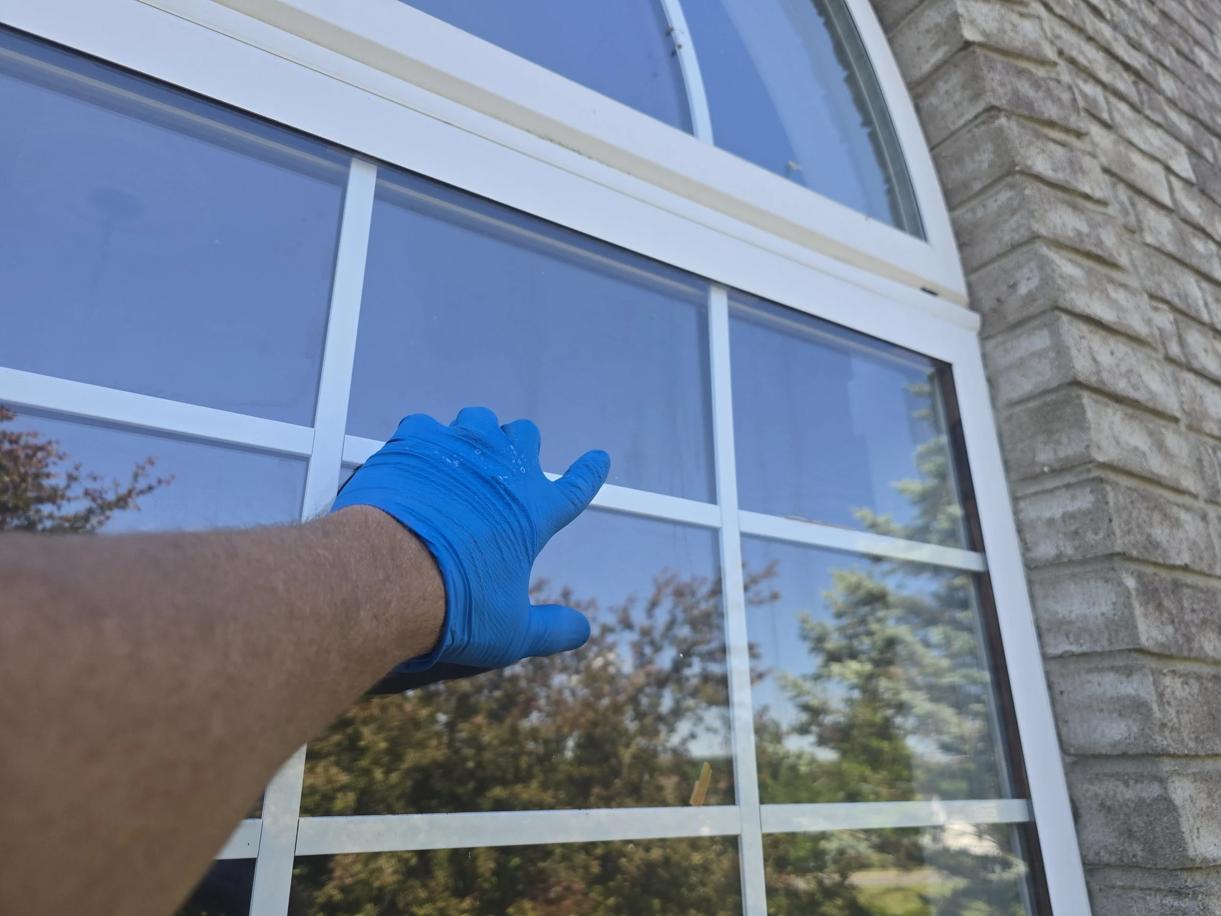 Meticulously pointing out issues in glass for client.