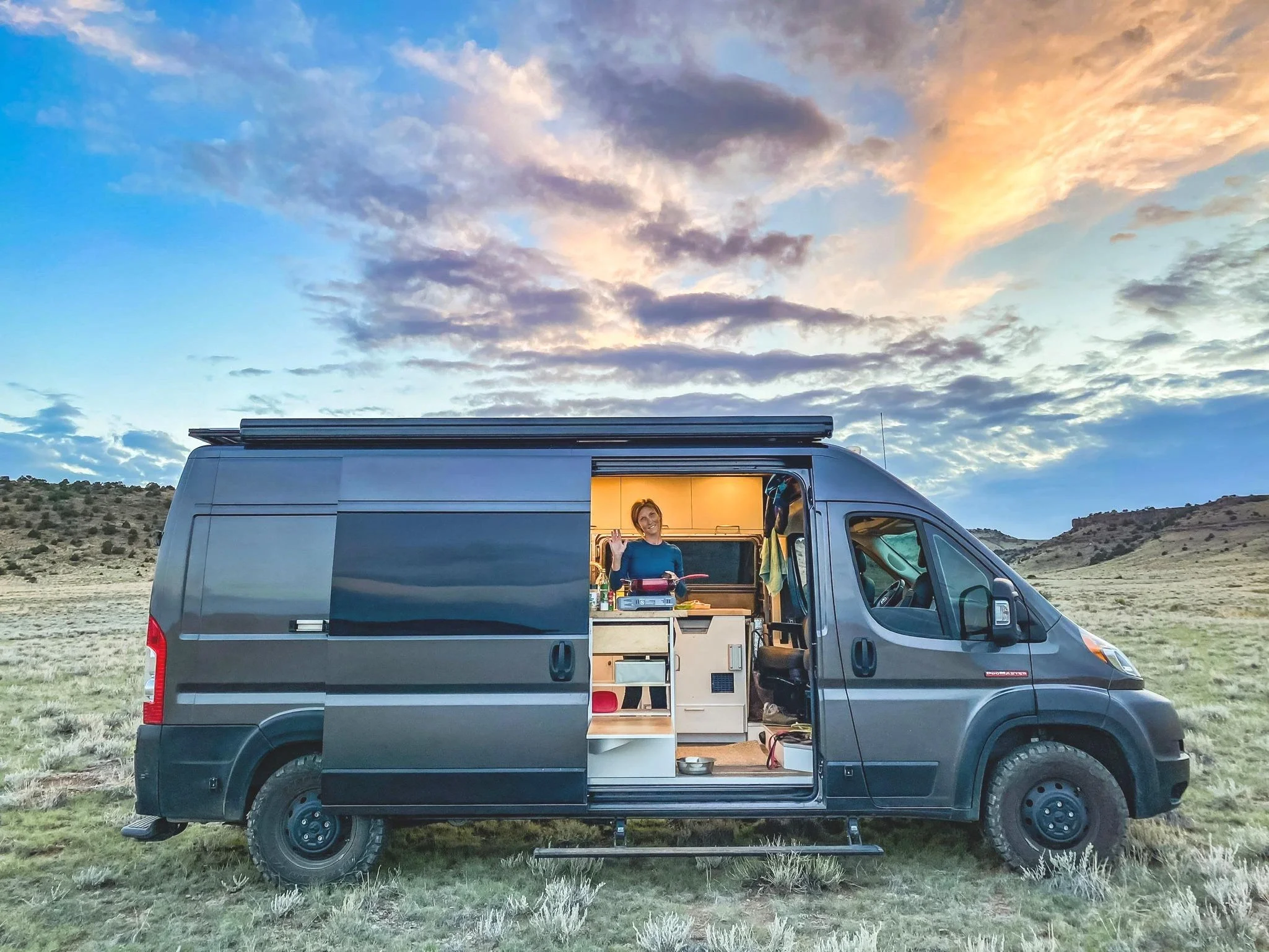 Camper vehicle parked in an open scenic landscape
