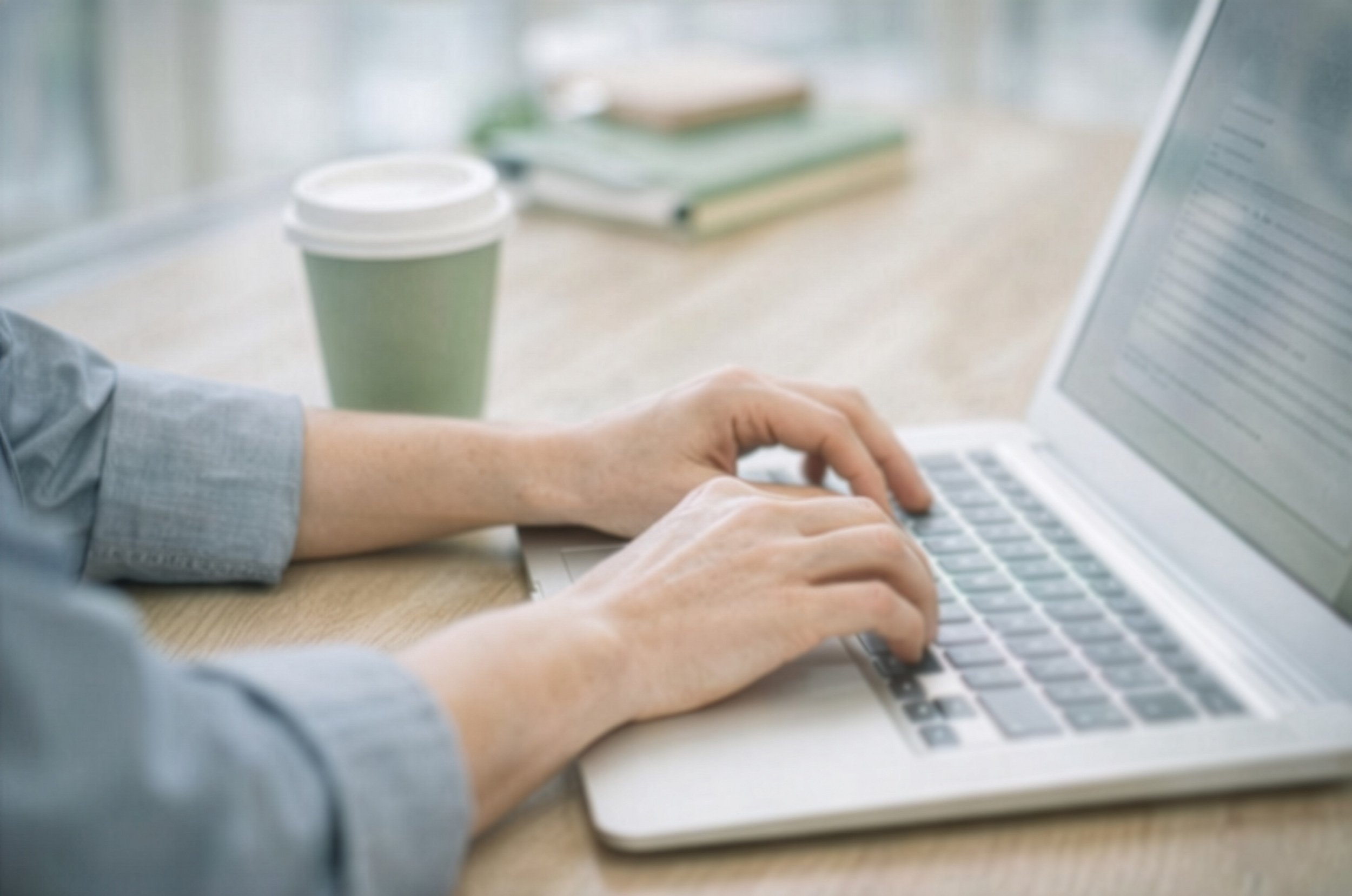 Professional working on a laptop to support organizational growth and people strategy