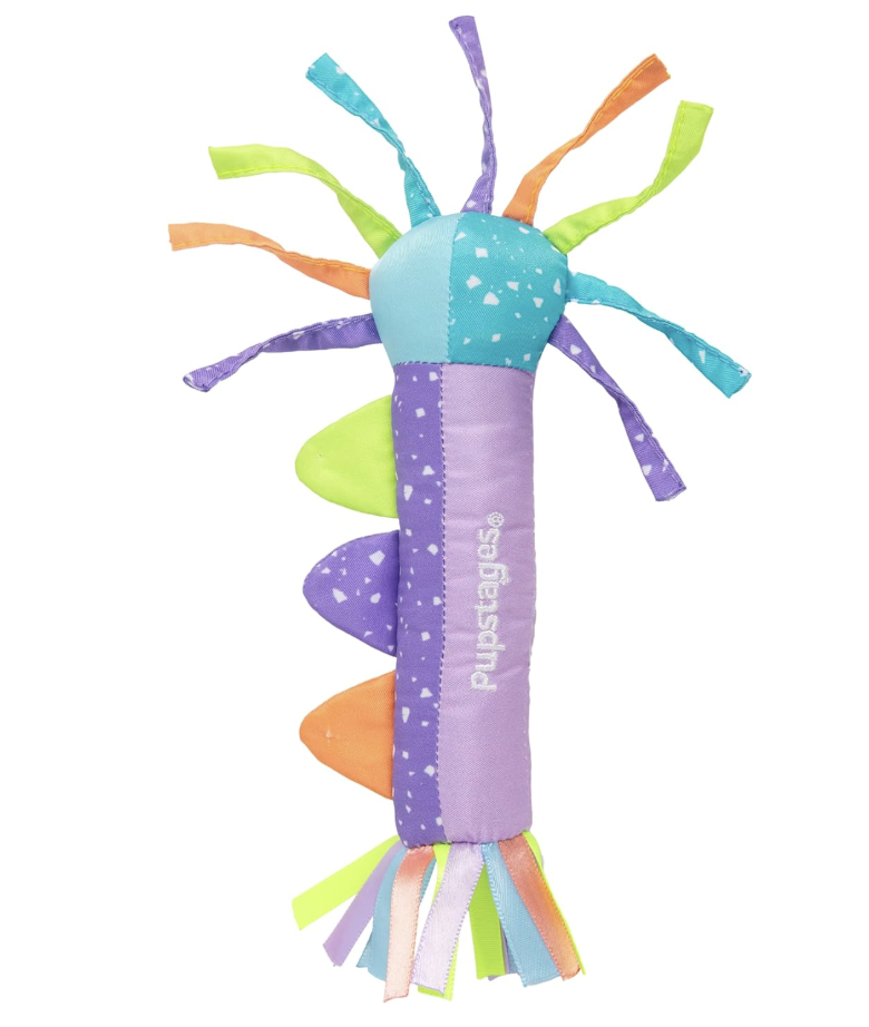 Colorful plush baby crib toy with multiple fabric strips and tags.