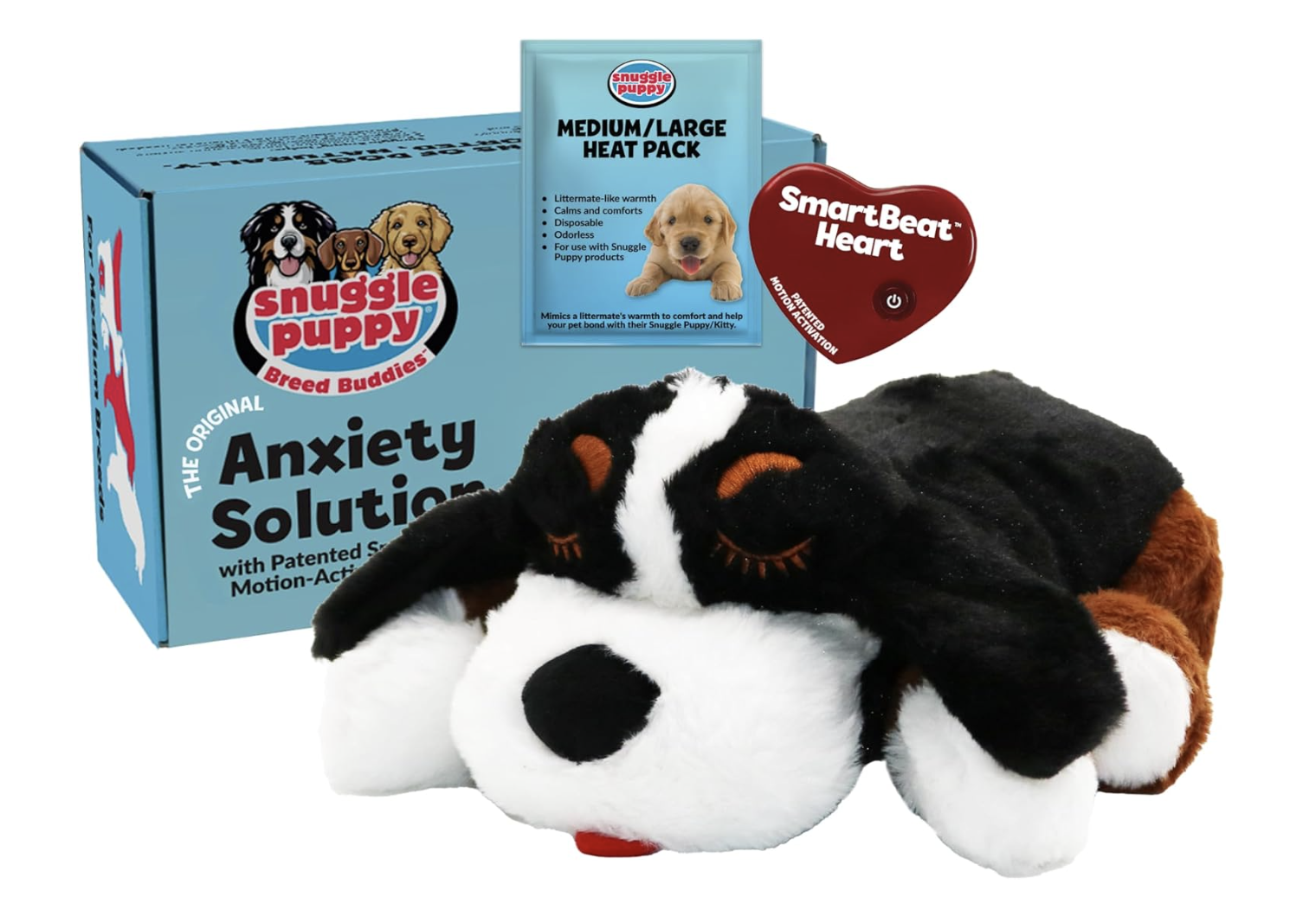 A plush dog toy with black, white, and brown coloring, lying in front of a blue box labeled 'Anxiety Solution' by Snuggle Puppy, with a medium/large heat pack and a red heart-shaped vibrating device.
