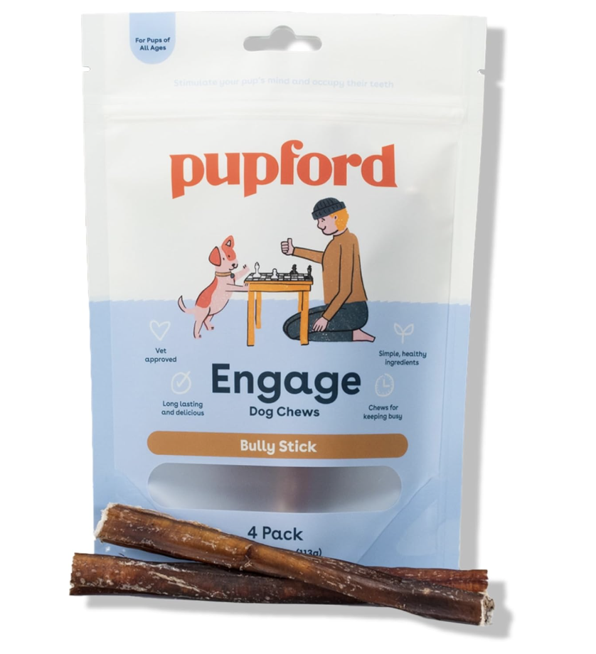 Dog chew treats labeled 'Engage' with 'Bully Stick' flavor, packaged in a bag with an illustration of a person and dog playing chess, and two bully sticks placed in front of the bag.