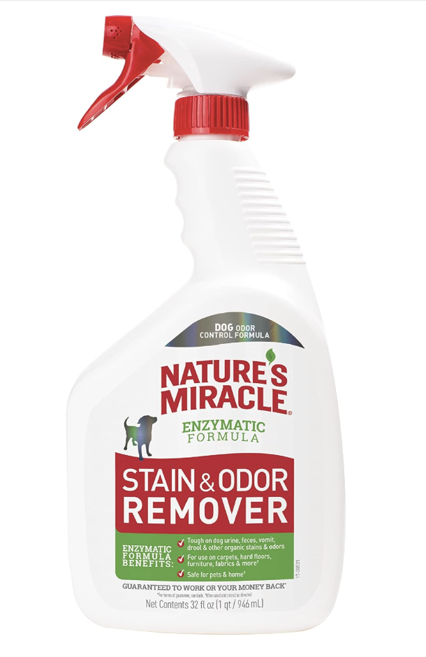 A white spray bottle labeled 'Nature's Miracle Enzymatic Formula Stain & Odor Remover' with a red trigger and cap.