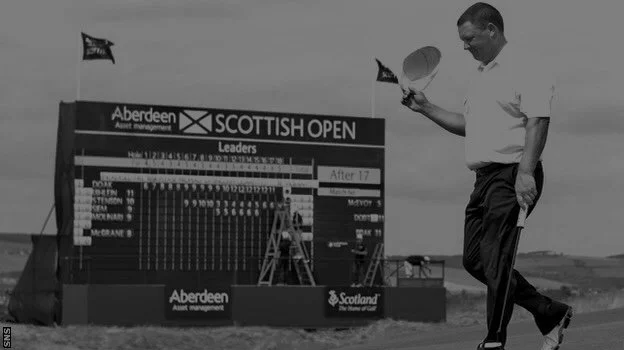 Chris Doak PGA top Scottish golf coach now at Otago Club Dunedin. Chris lifts his cap as he walks off the 18th green at Castle Stuart Golf Course, Inverness, Scotland. The scoreboard in the background shows that he is the tournament leader.