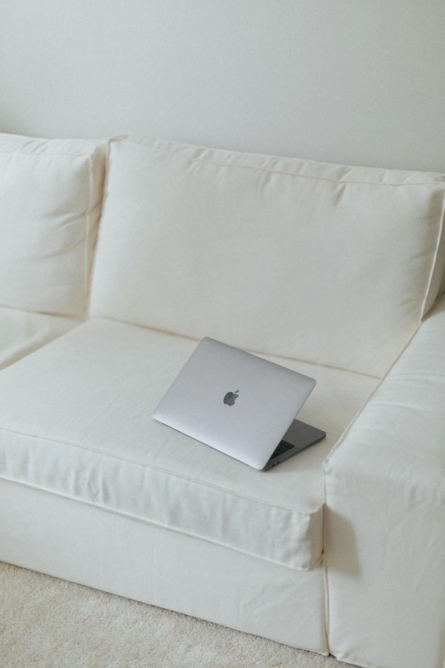 Laptop on white couch