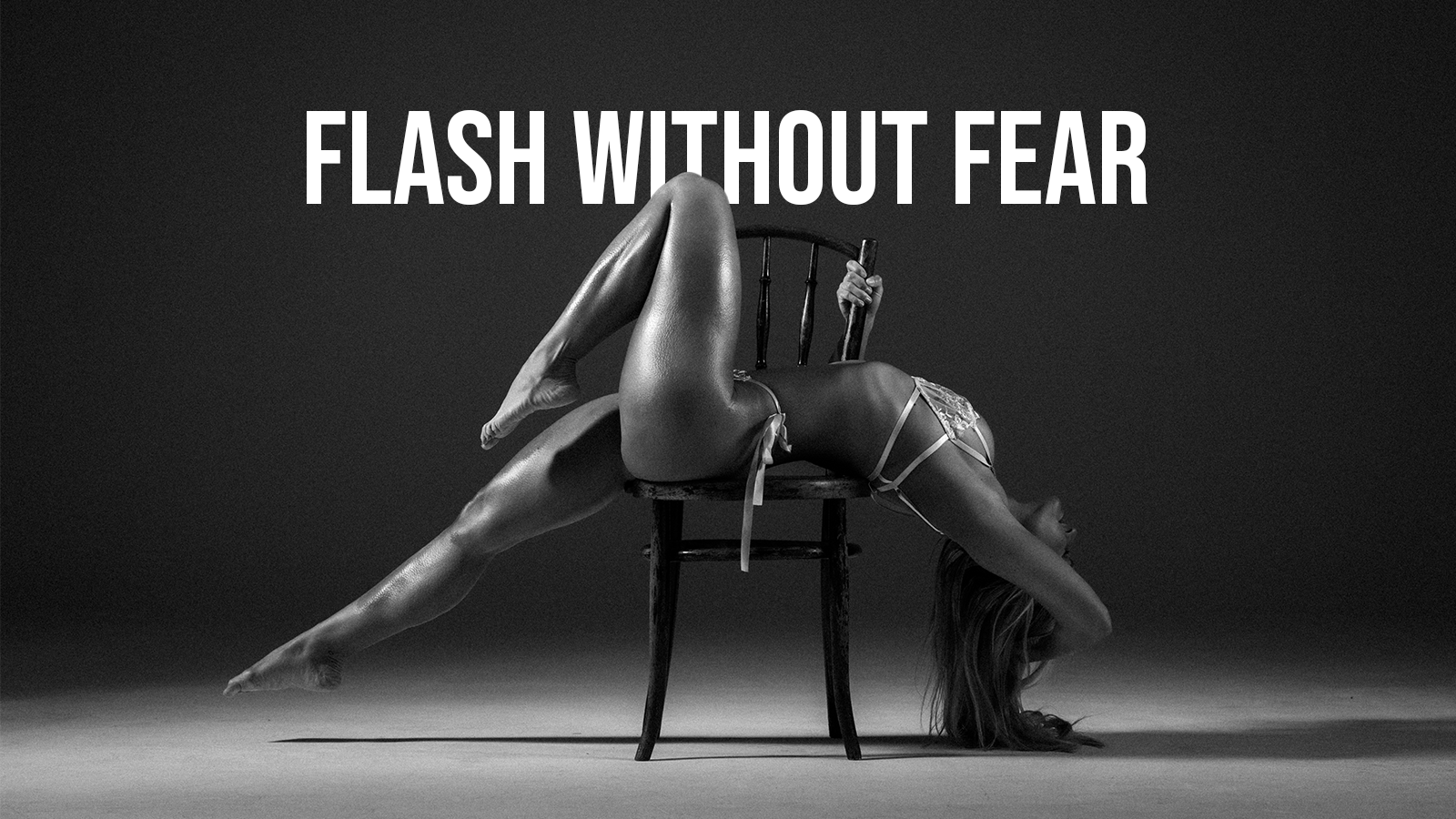 A woman in lingerie performing a contorted pose with her head and arm hanging upside down behind a chair, and her legs resting on the seat of the chair, with the text "FLASH WITHOUT FEAR" above her in bold letters.