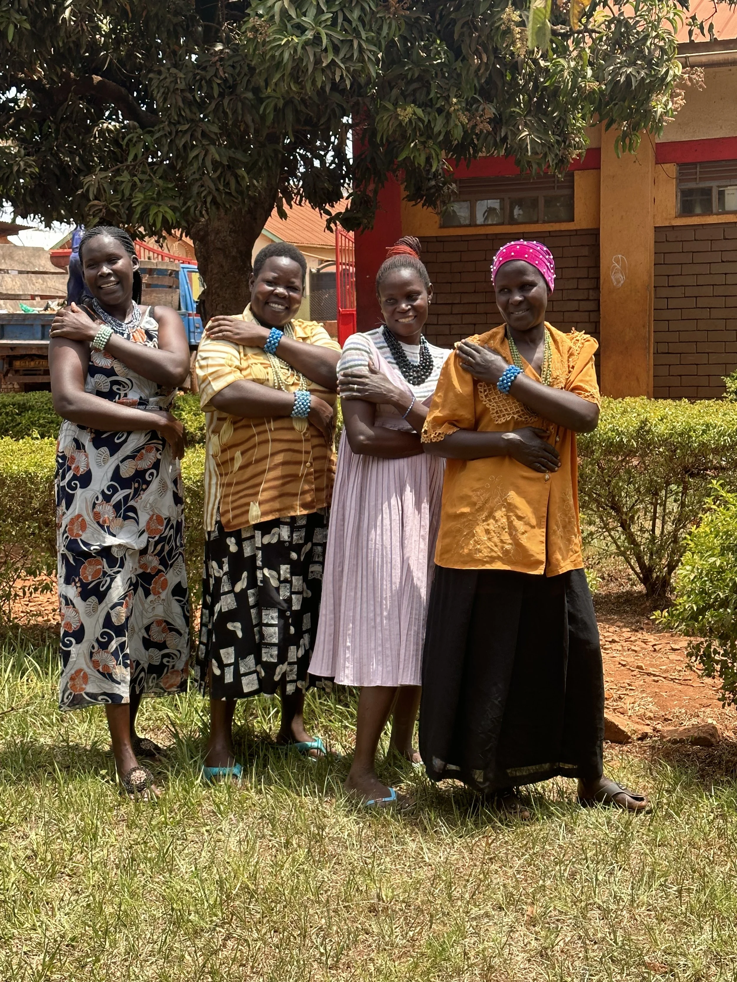 4 women smiling beads story.jpeg