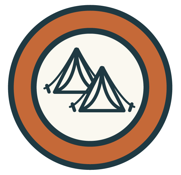 Icon of two tents inside a circular border, representing camping.