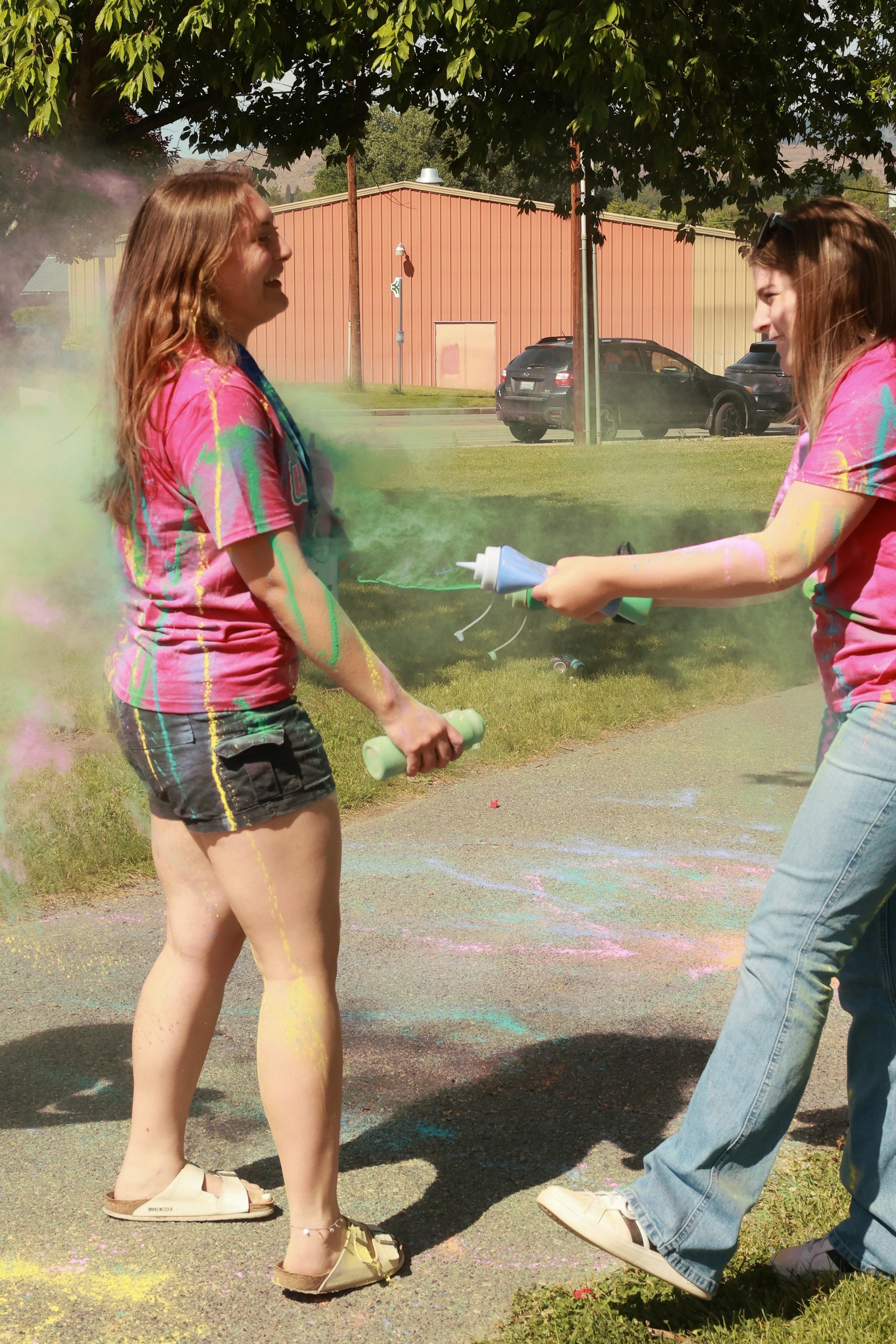 Photo of teen girls spraying eachother with color at OBHC's 2026 Color Walk.