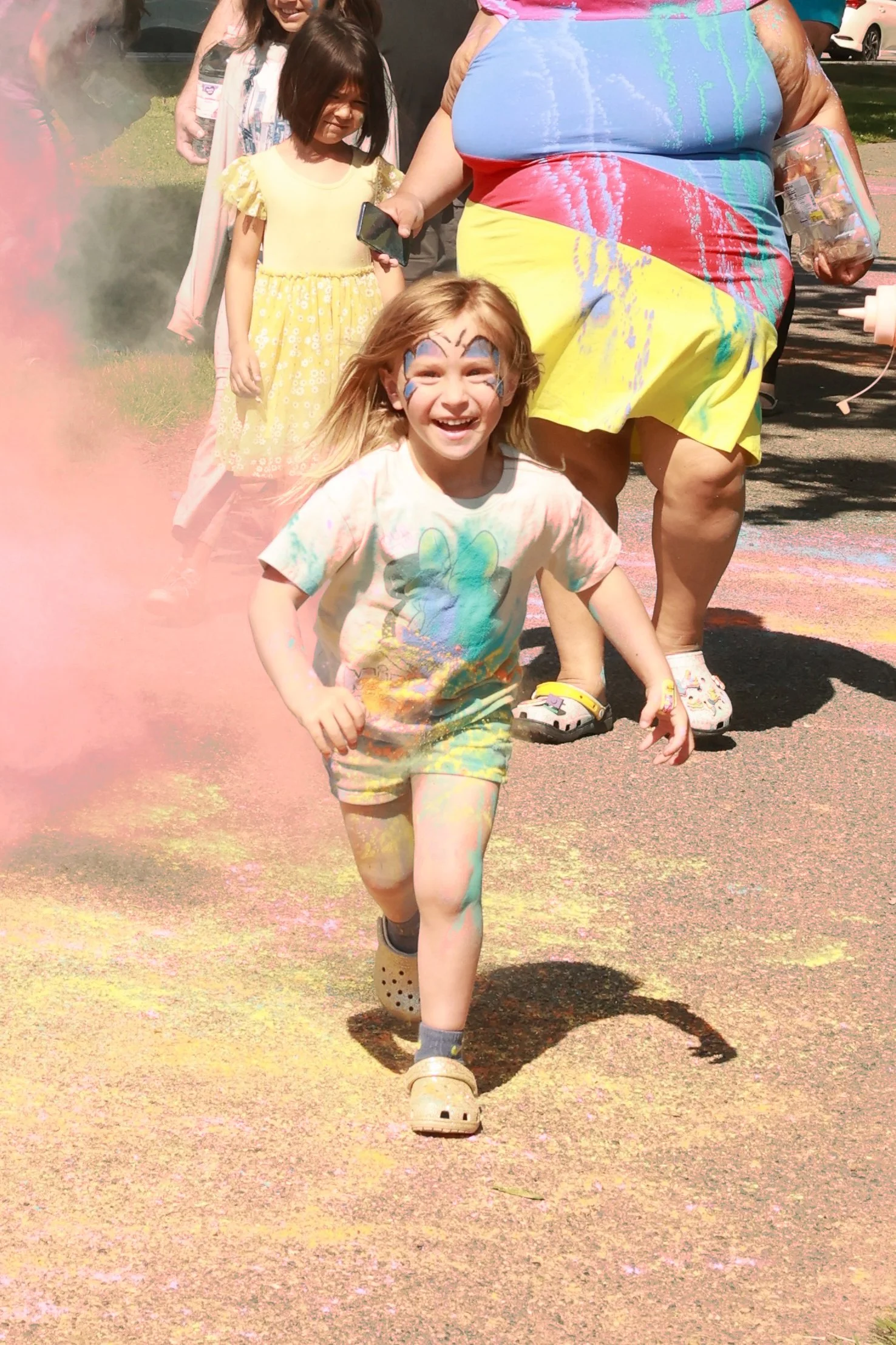 Photo of a girl running at OBHC's 2026 Color Walk.