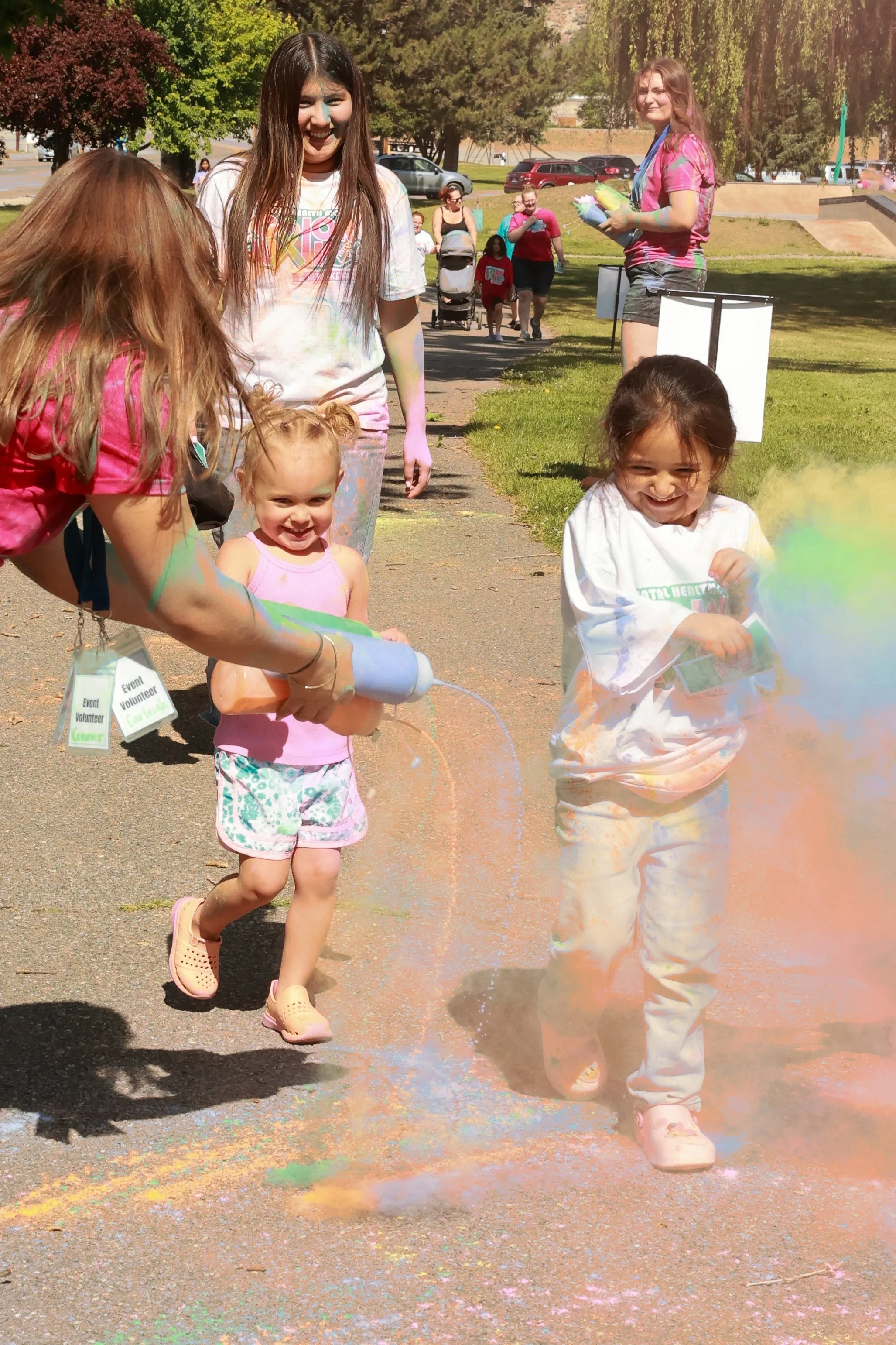 Photo of girls being sprayed with color at OBHC's 2026 Color Walk.