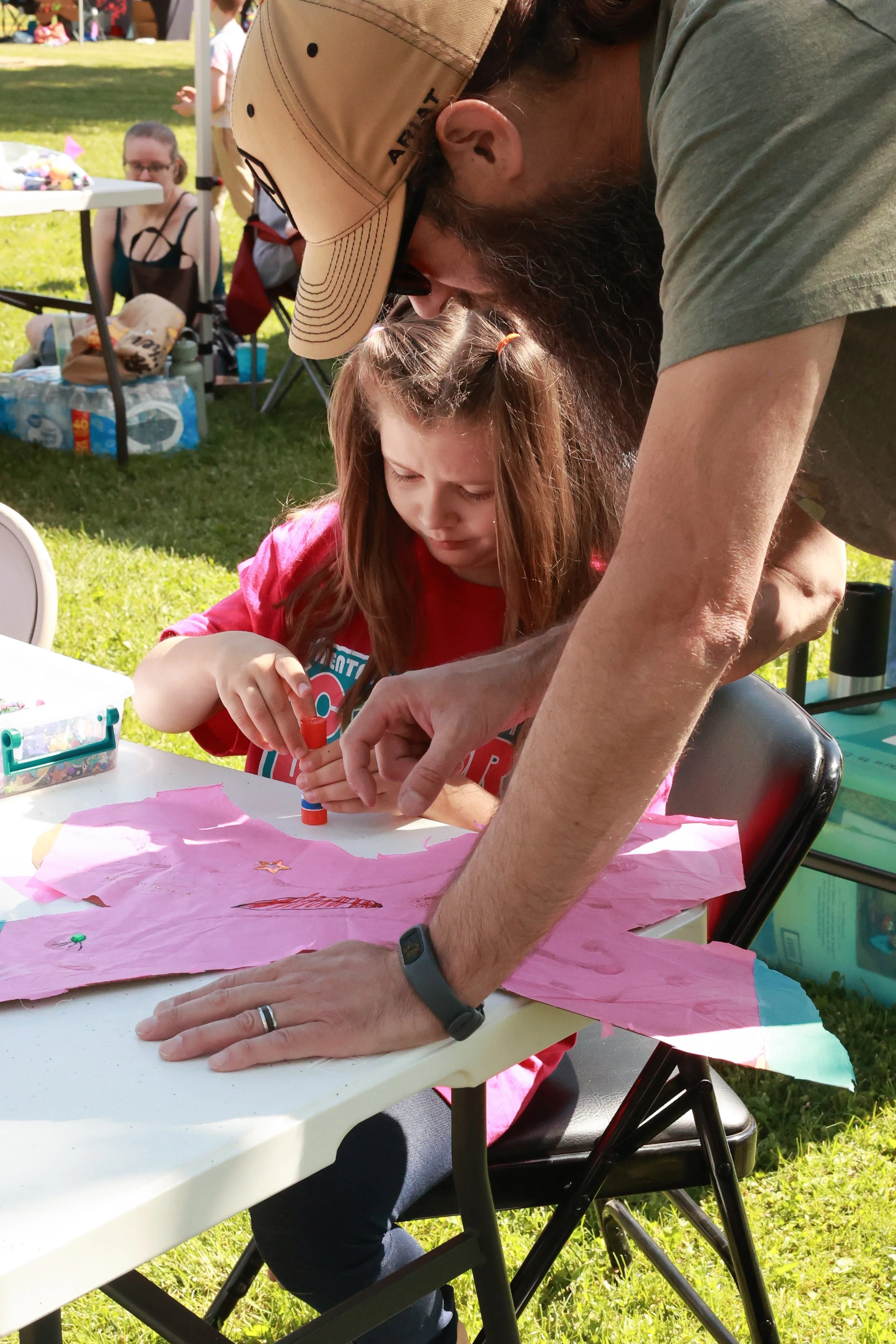 Photo of a dad and daughter working on a craft together at OBHC's 2026 Color Walk.