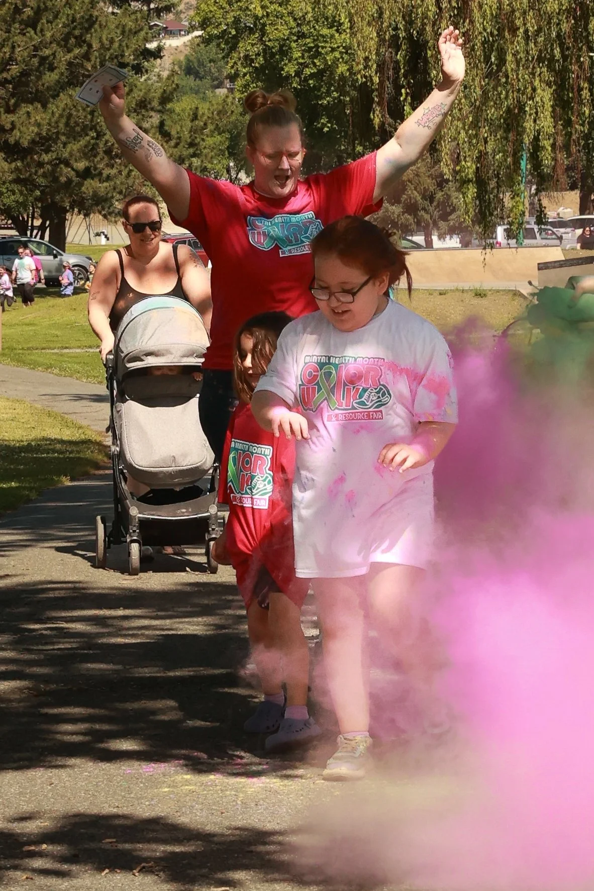 Photo of a family being sprayed with color at OBHC's 2026 Color Walk.