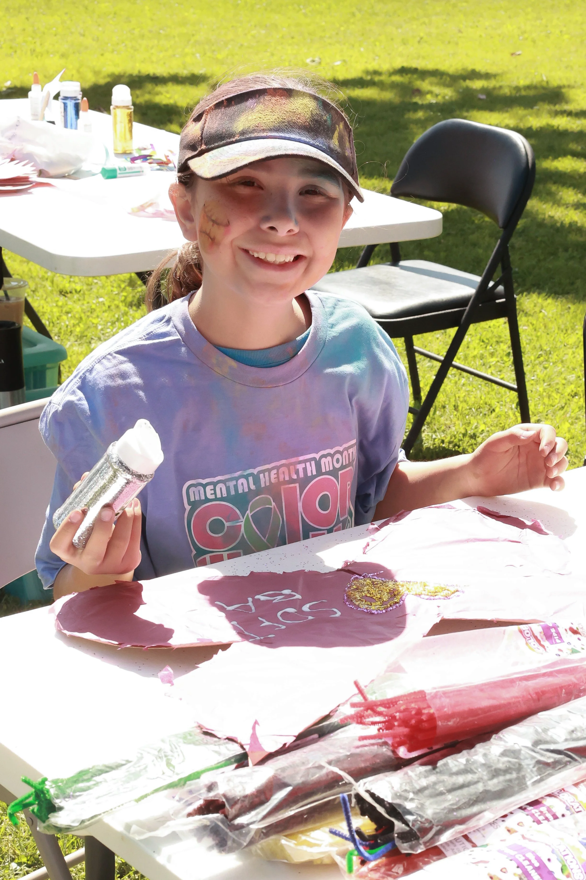 Photo of a girl working on a craft at OBHC's 2026 Color Walk.