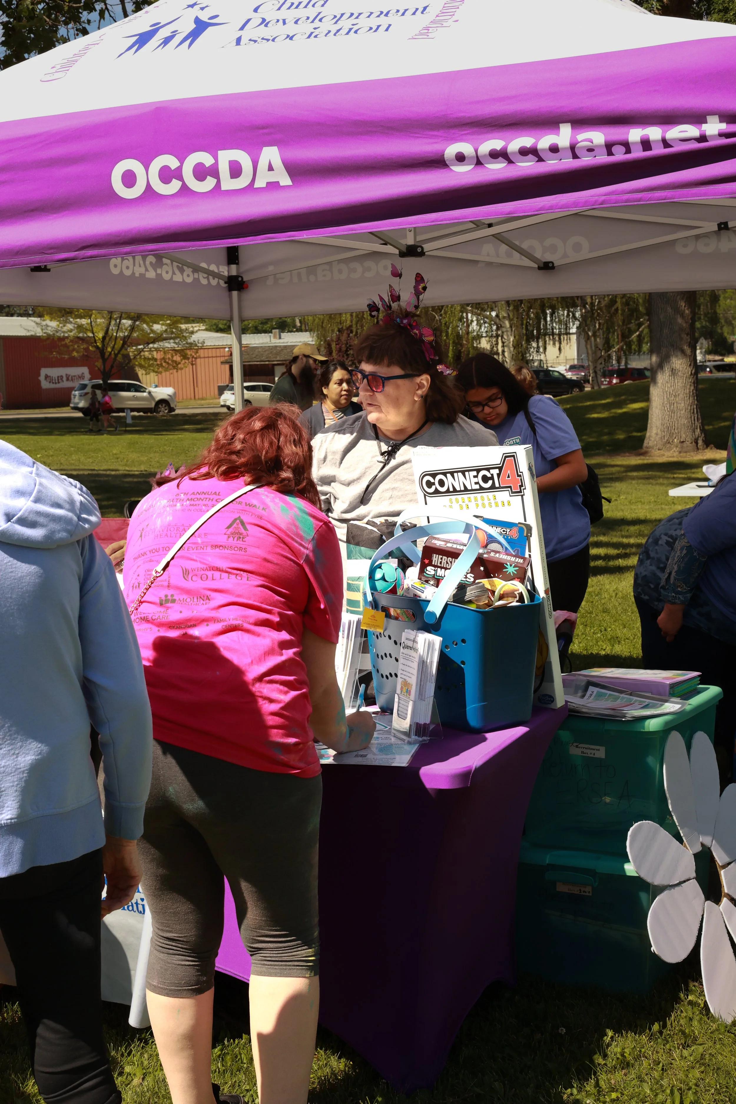 Photo of an OCCDA vendor talking to a community member at OBHC's 2026 Color Walk.
