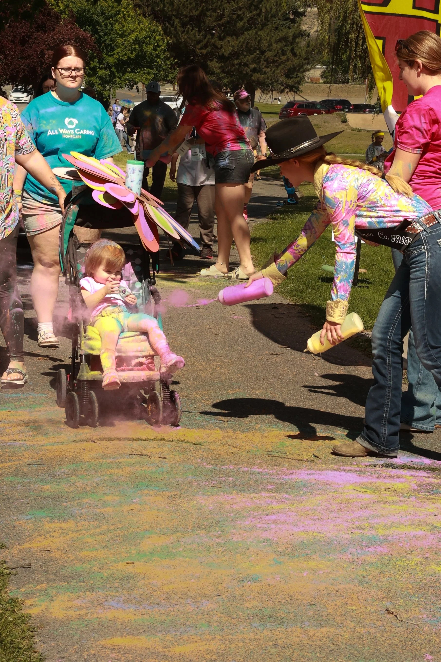 Photo of a child being sprayed with color at OBHC's 2026 Color Walk.