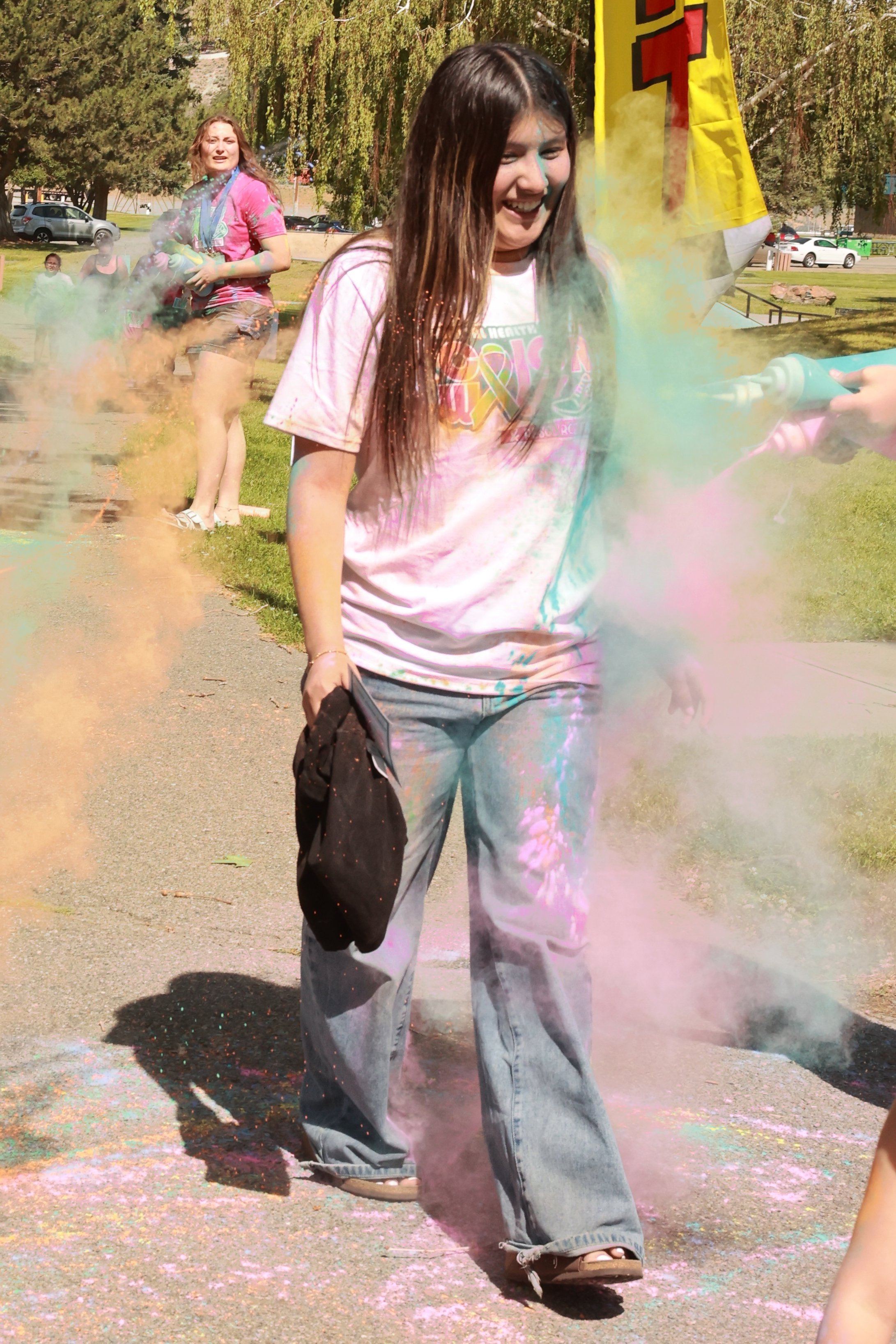 Photo of a girl being sprayed with color at OBHC's 2026 Color Walk.