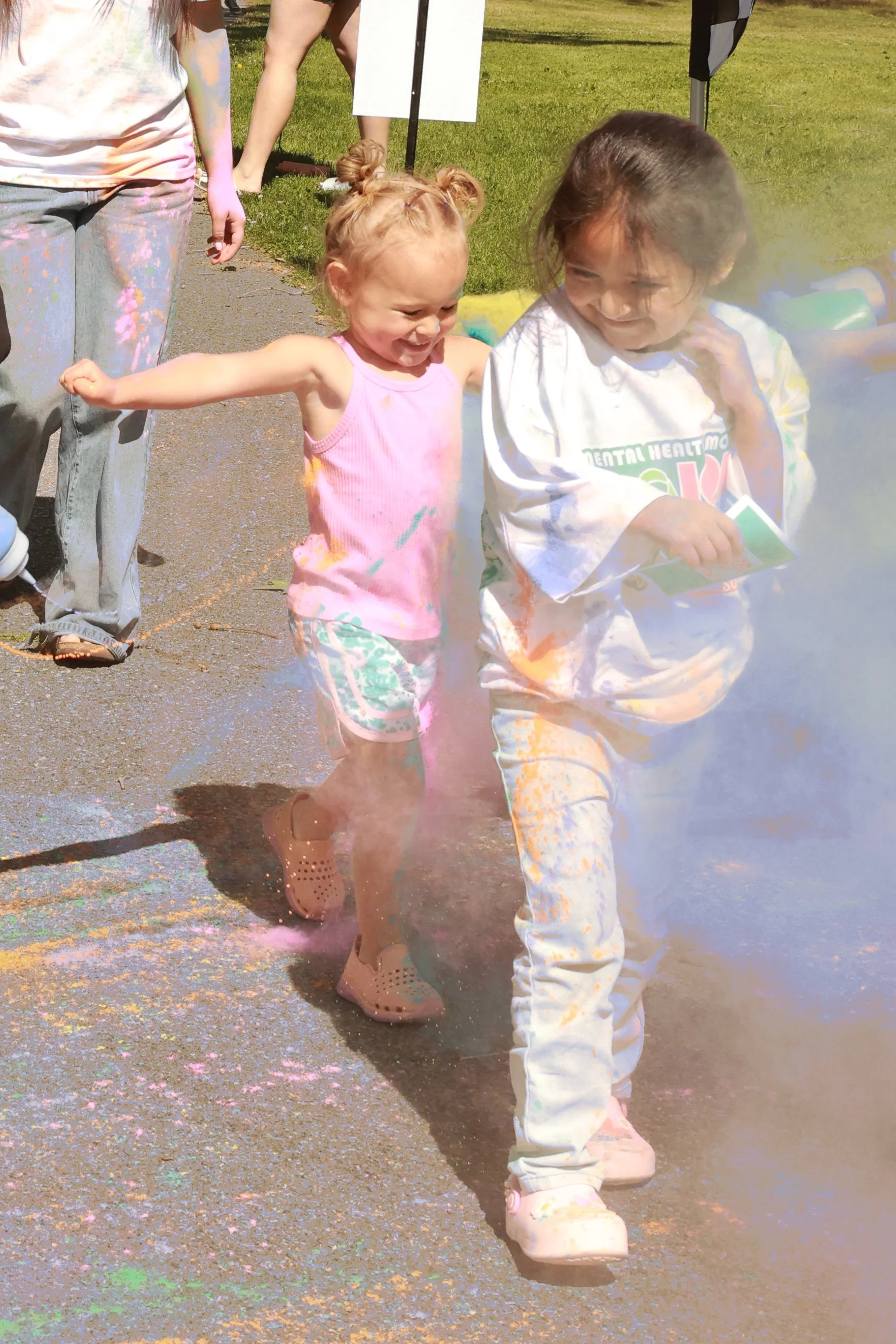 Photo of girls being sprayed with color at OBHC's 2026 Color Walk.