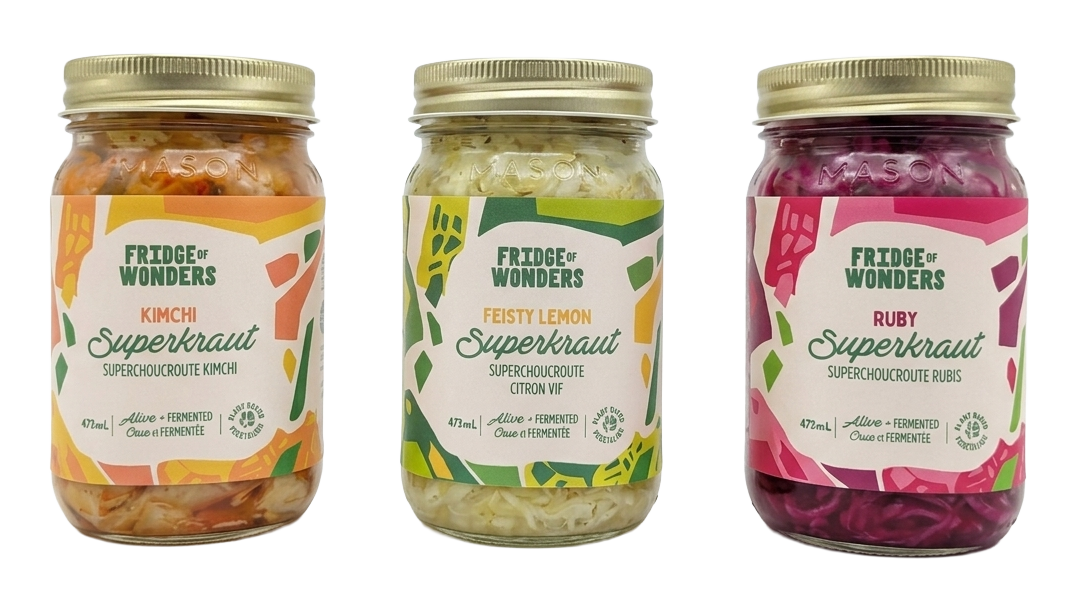 Three jars of fermented supercrouture vegetables from Fridge of Wonders, featuring kimchi, lemon, and ruby varieties, on a white surface.