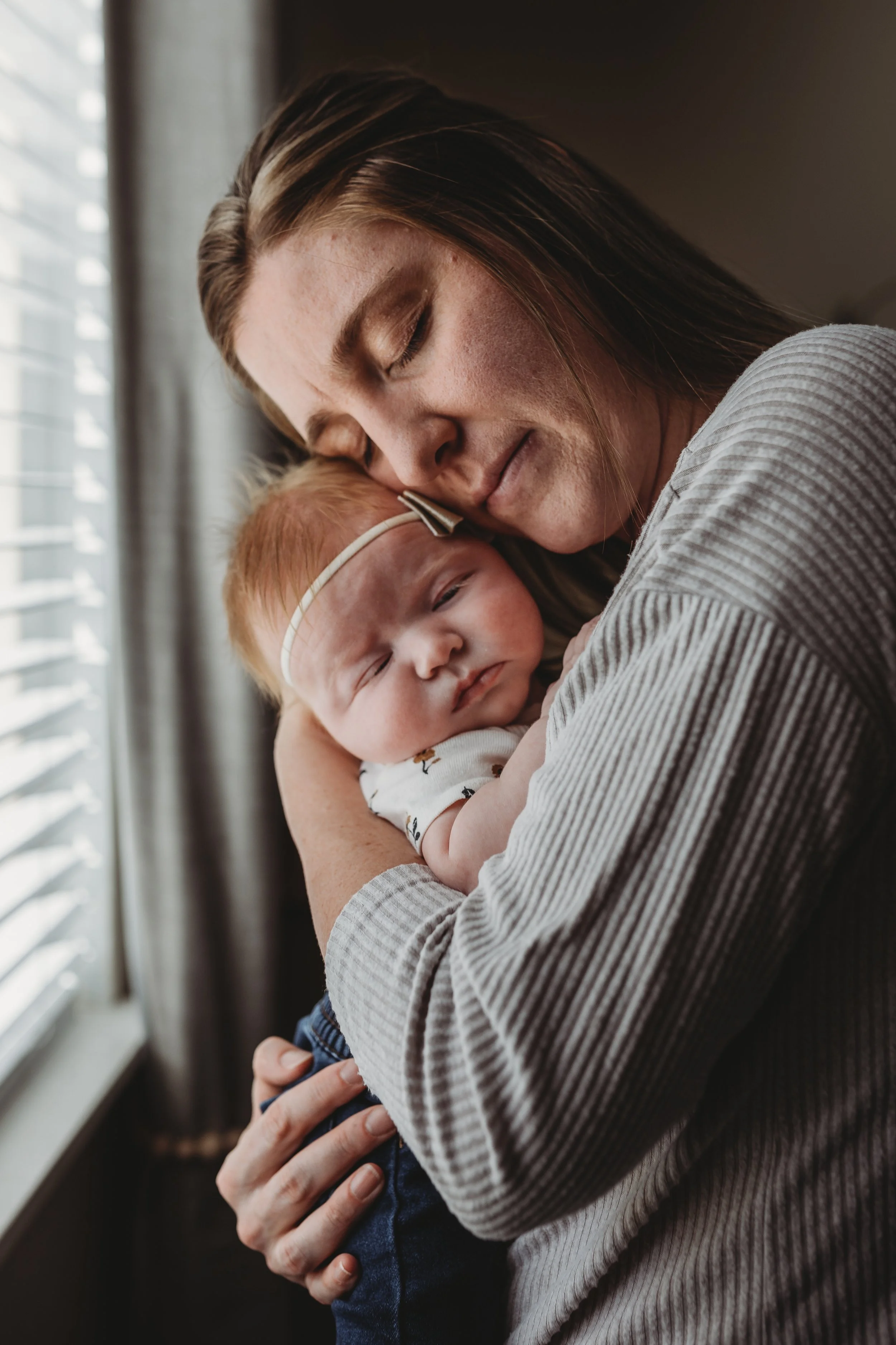 Mom-and-daughter-snuggling-in-home-nursery-colorado-springs.jpg