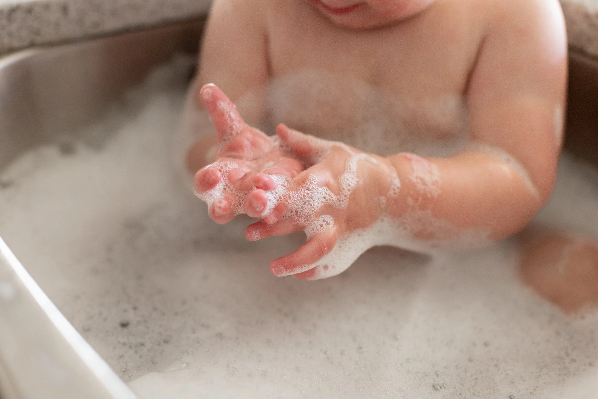 baby-sink-bubbles-bath-tub-playing-bath-tim-hands-first-birthday-colorado-springs.jpg