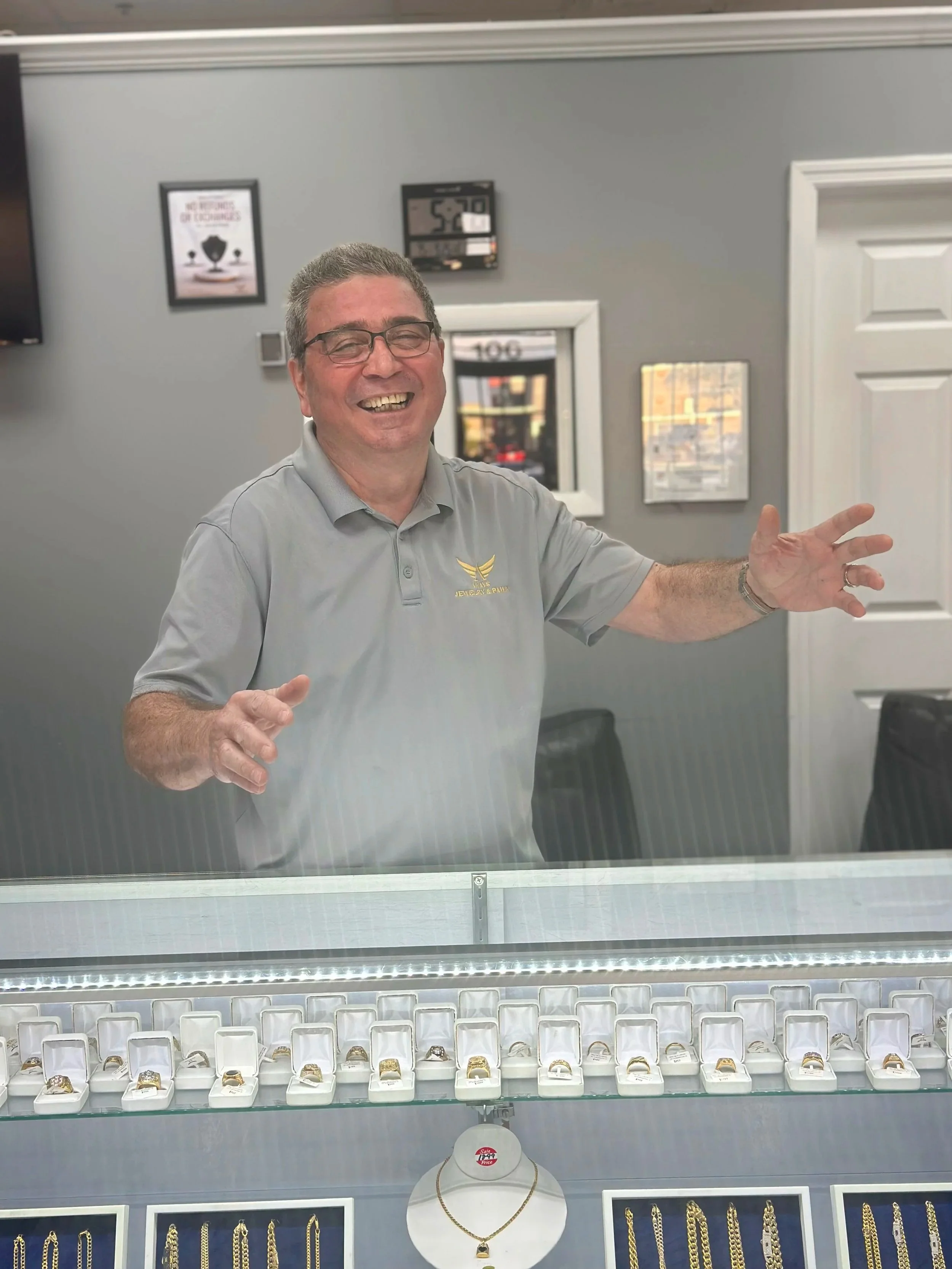 nelson is standing behind the display cases