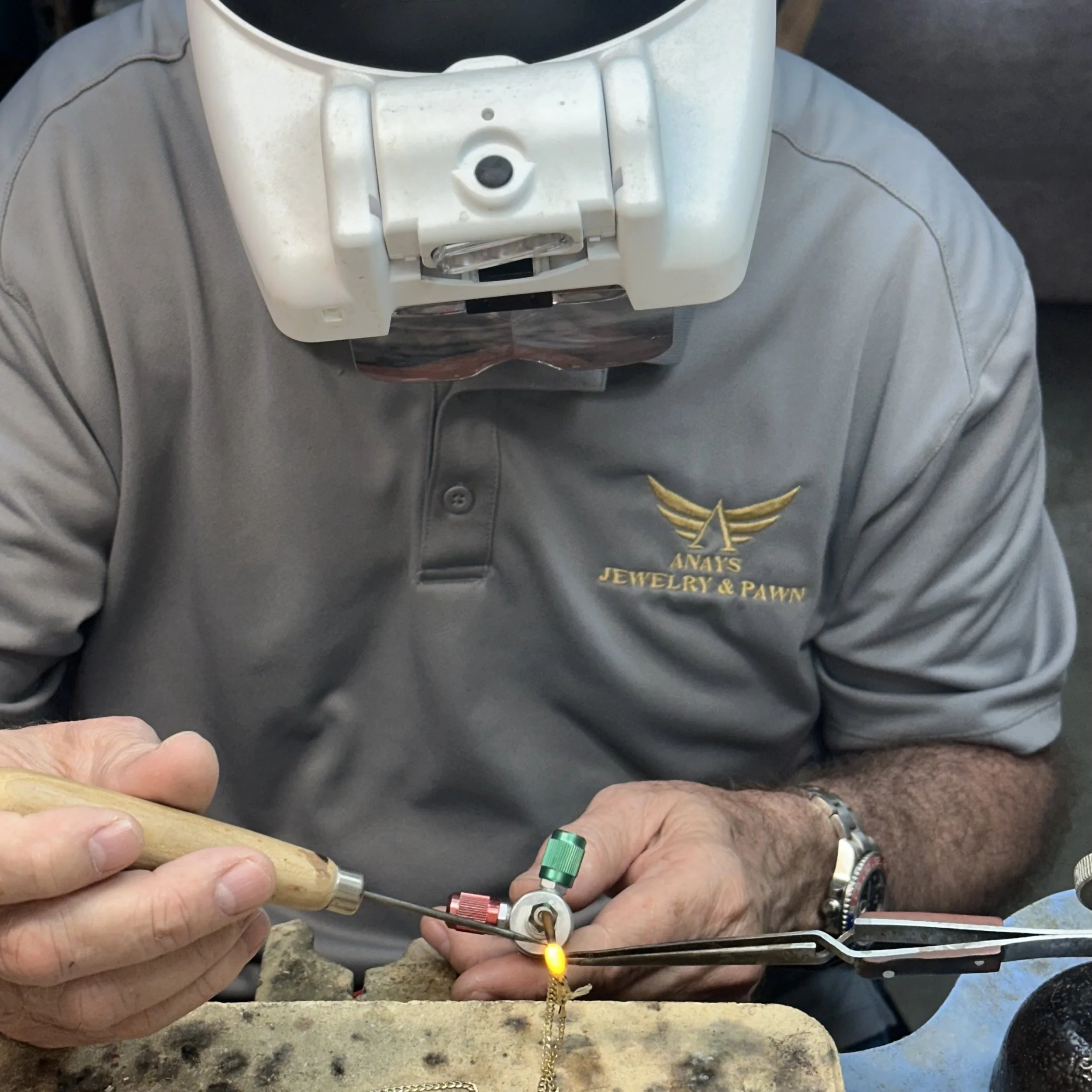 Nelson welds a gold chain