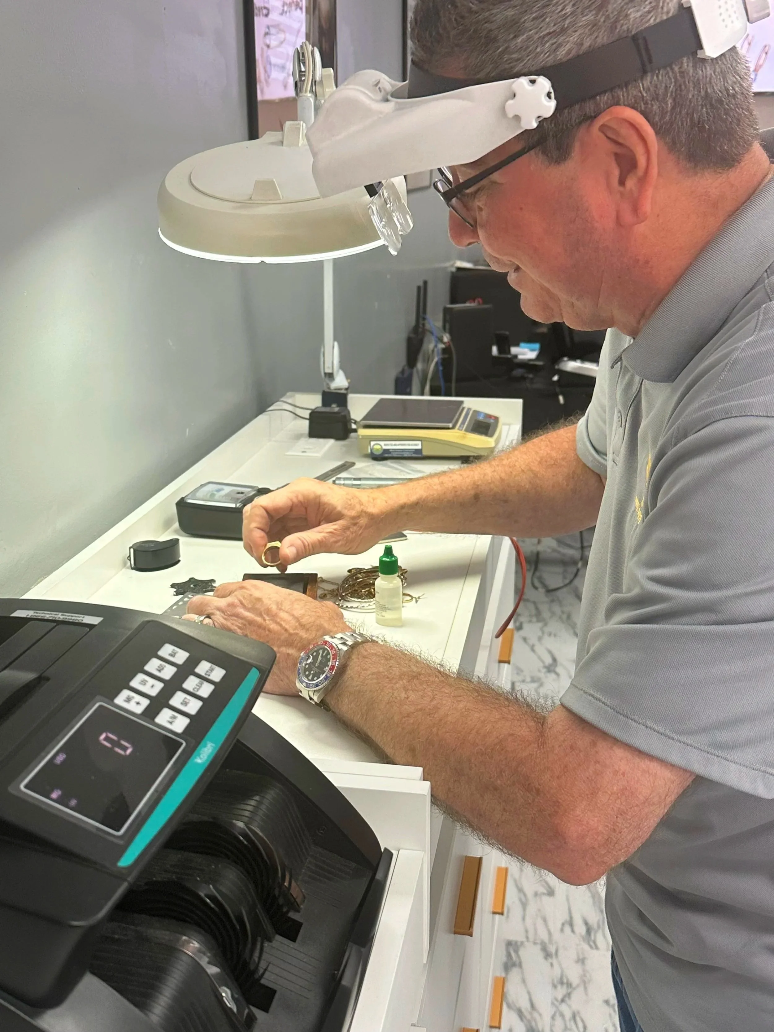 jeweler conducting a acid scratch test on ring