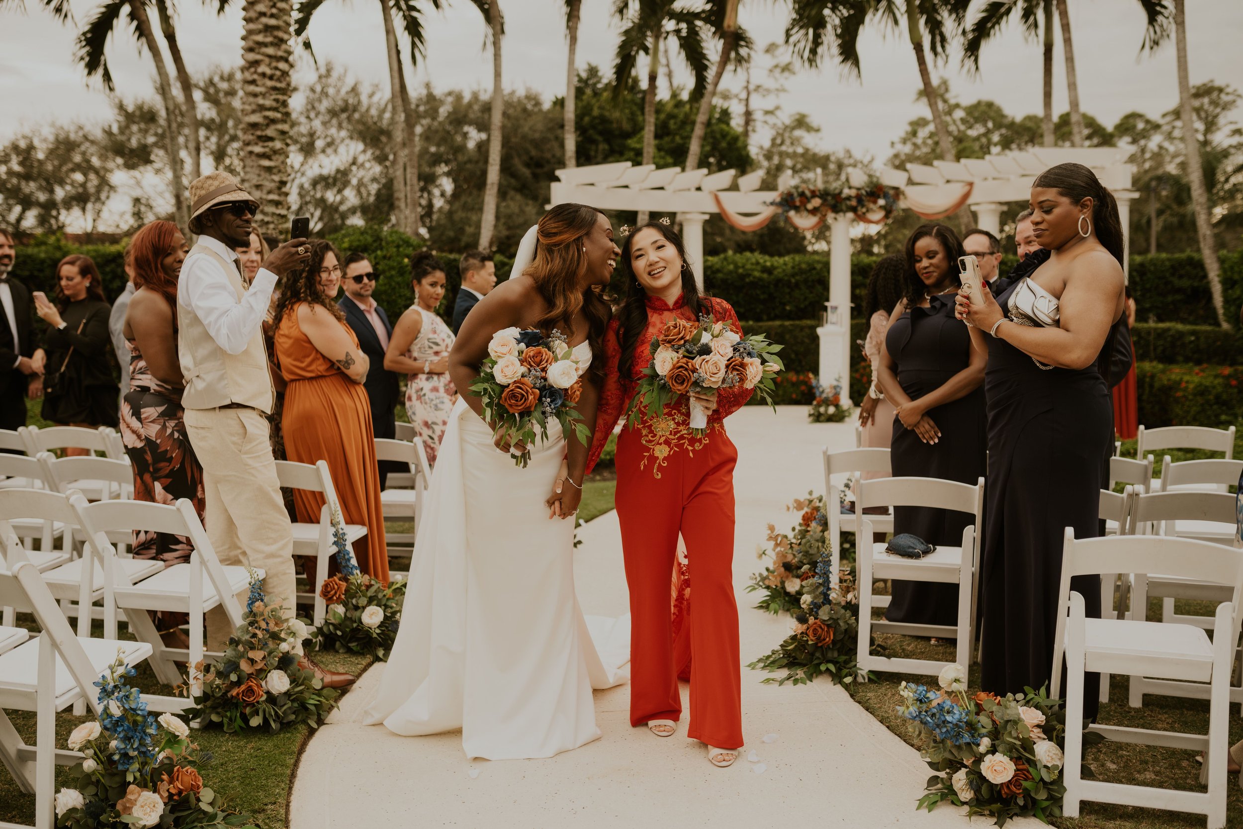 Lesbian wedding ceremony at The Club at Grandézza near Fort Myers with guests watching emotional vows.
