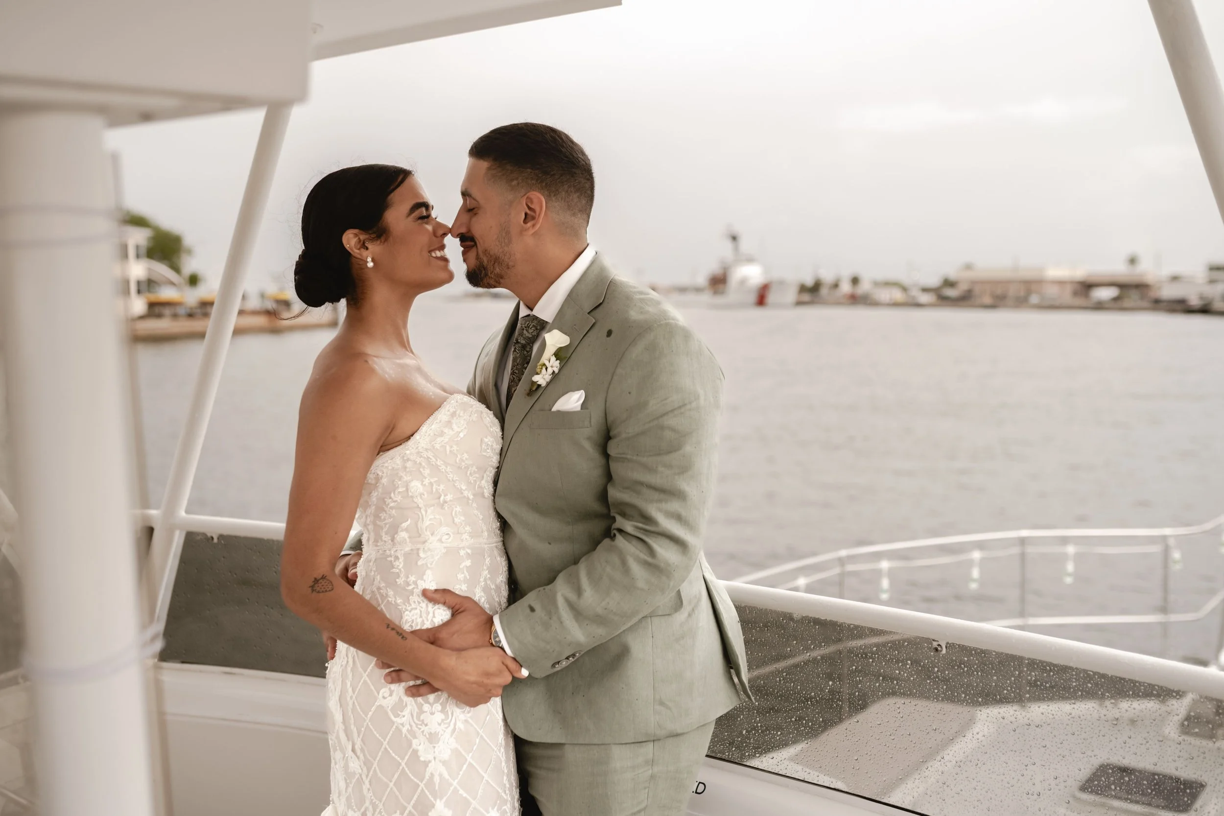 Yacht wedding in Tampa Bay featuring a romantic waterfront ceremony, elegant floral details, and joyful couple celebrating with family and friends aboard a luxury yacht at sunset.