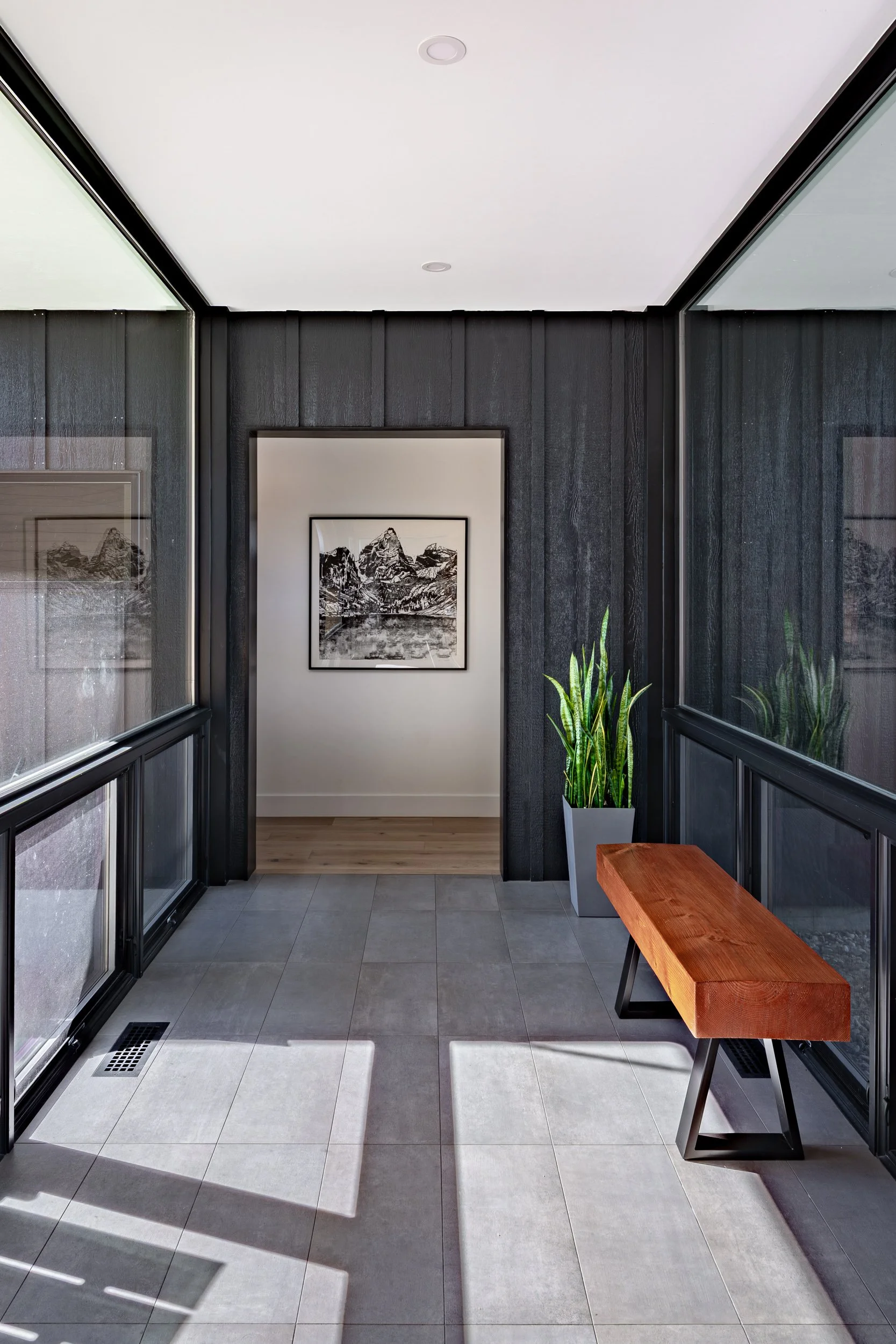 Glazed interior corridor in Scandinavian modern residence designed by Trimbach Builders & Design Studio