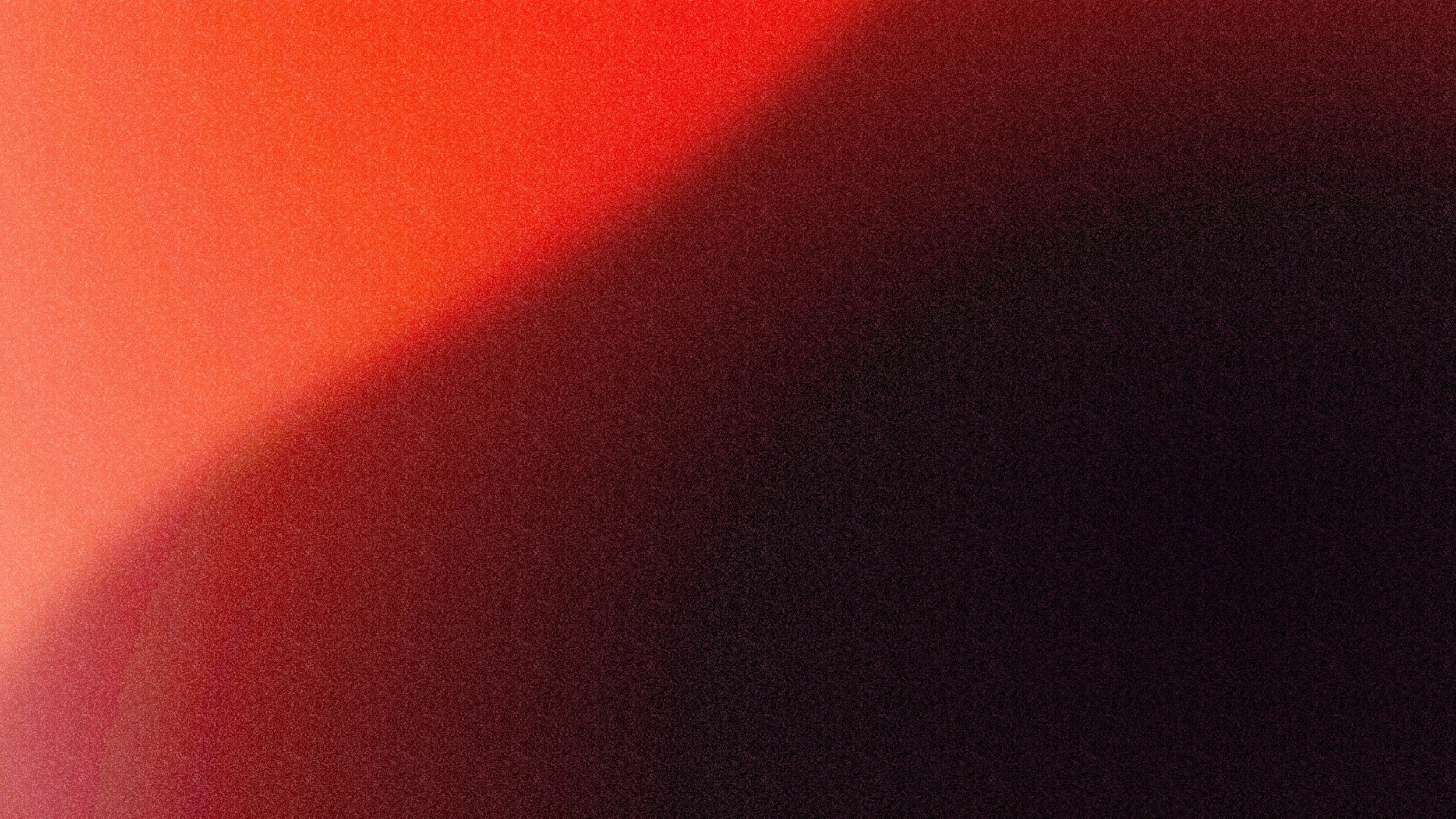 An abstract gradient background with shades of red, pink, and black blending together.