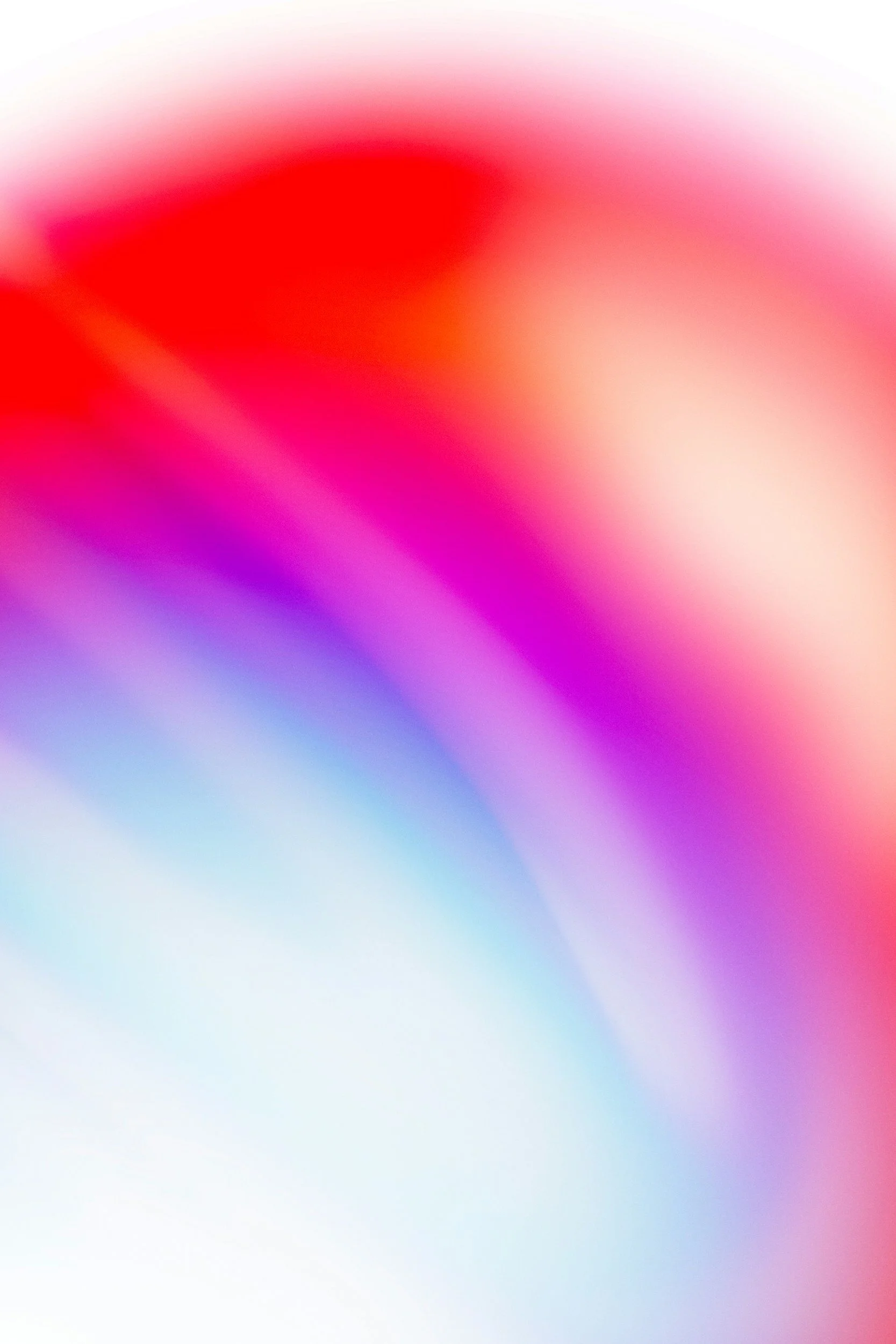 Blurred abstract image with red, pink, purple, and blue colors.