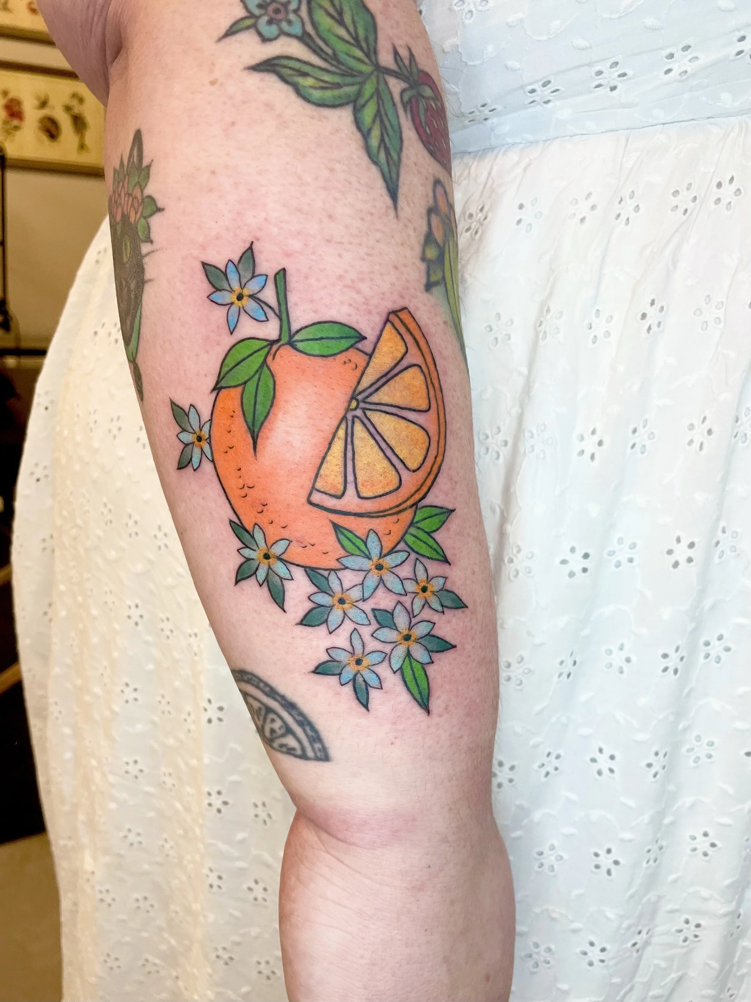 Traditional orange tattoo by Jennifer Lynn at Crown Jewel Tattoo in Tampa Florida 