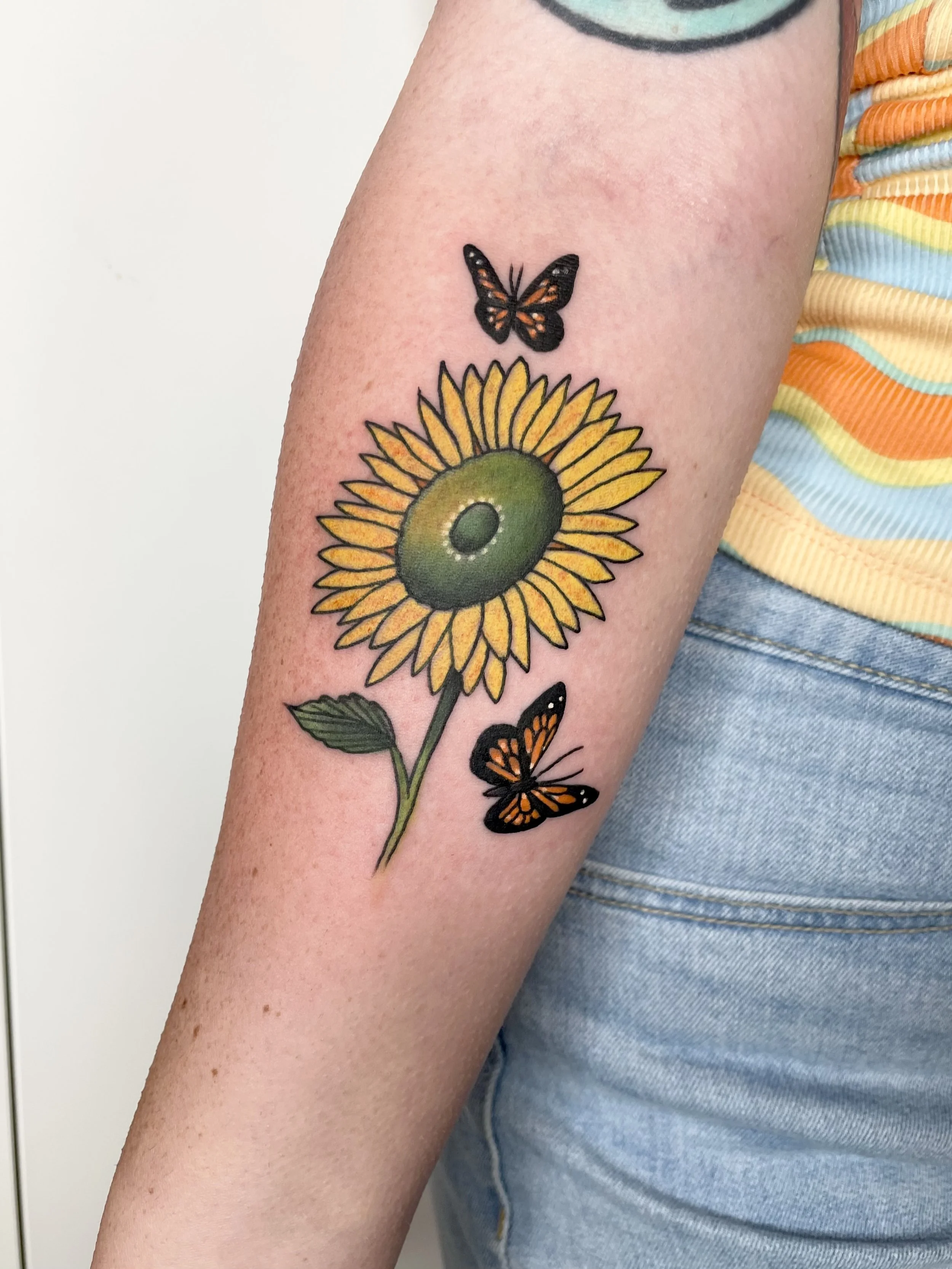 Traditional sunflower tattoo by Jennifer Lynn at Crown Jewel Tattoo in Tampa Florida 