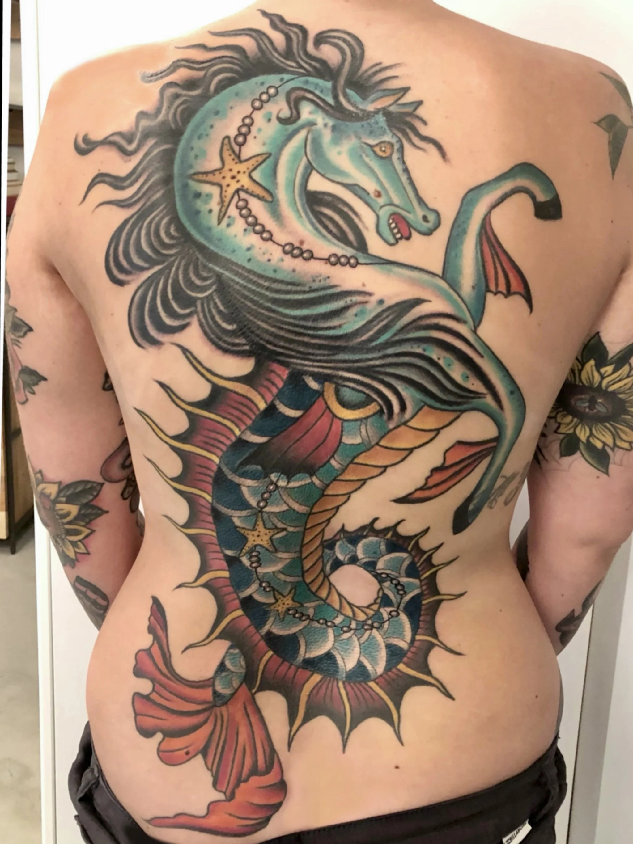 Traditional back piece tattoo by Jennifer Lynn at Crown Jewel Tattoo in Tampa Florida.
