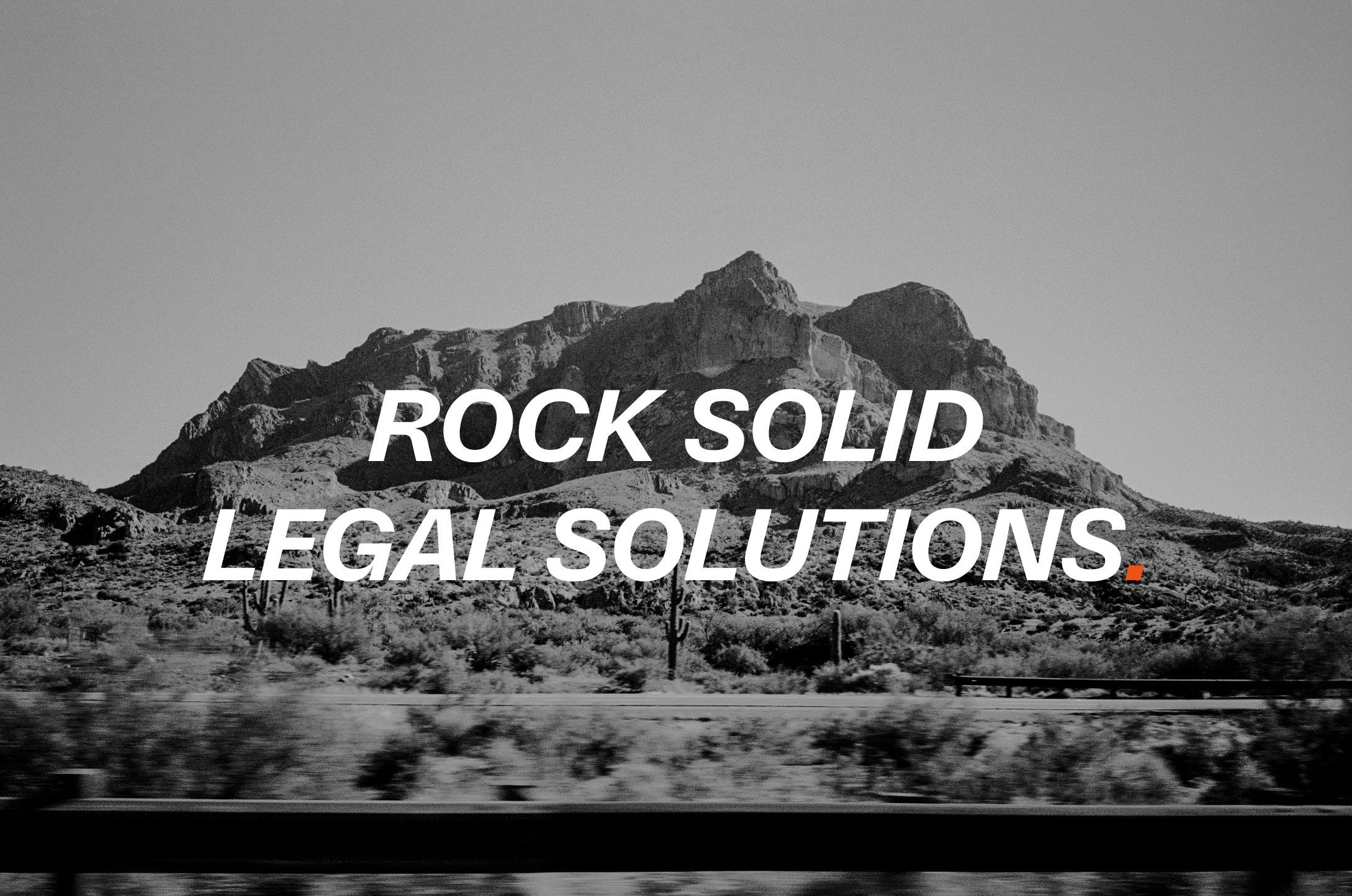 Black and white landscape of mountainous desert terrain, overlaid with white text reading 'Rock Solid Legal Solutions'.