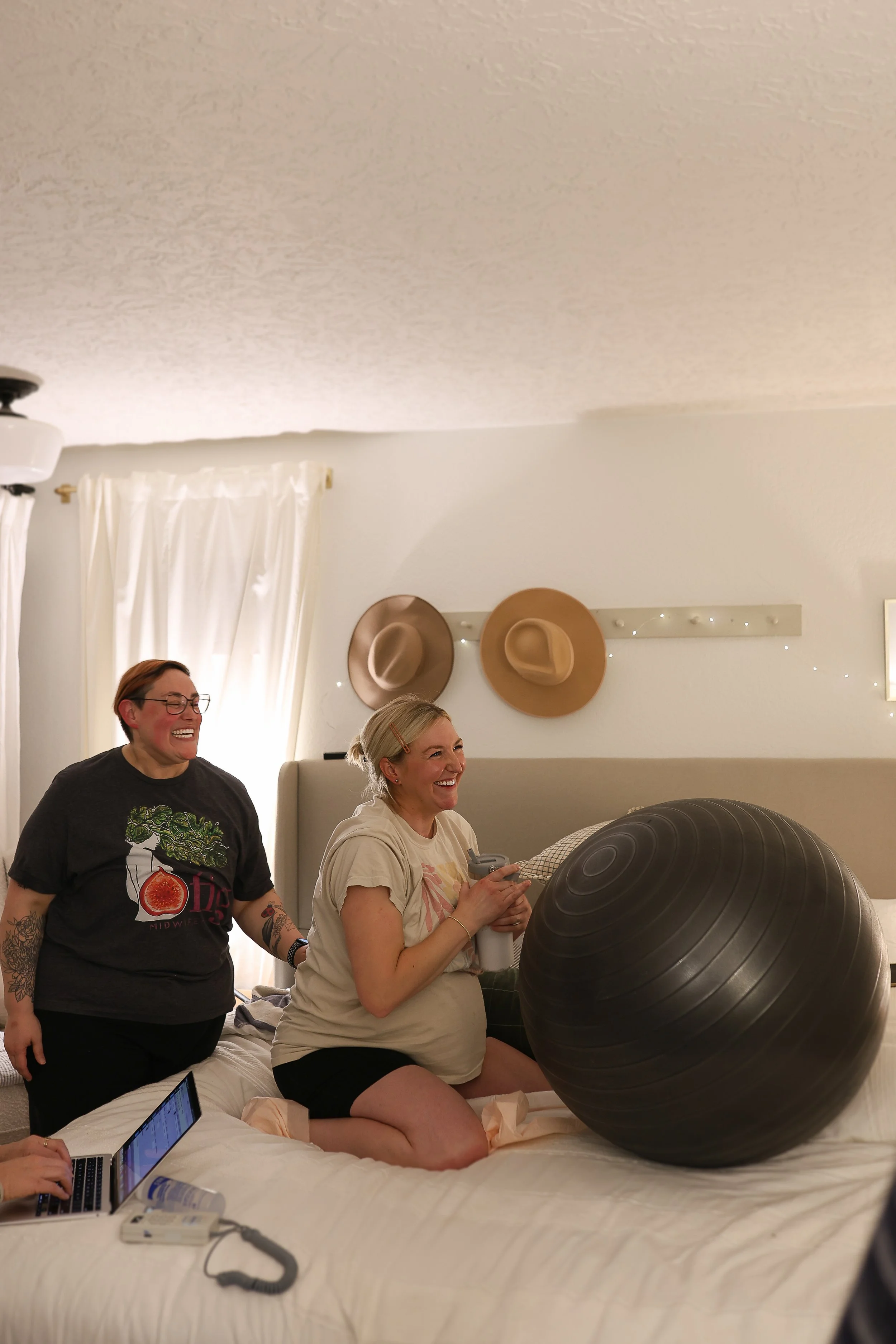 Two women, one in labor and the other providing labor support and suggesting laboring positions.