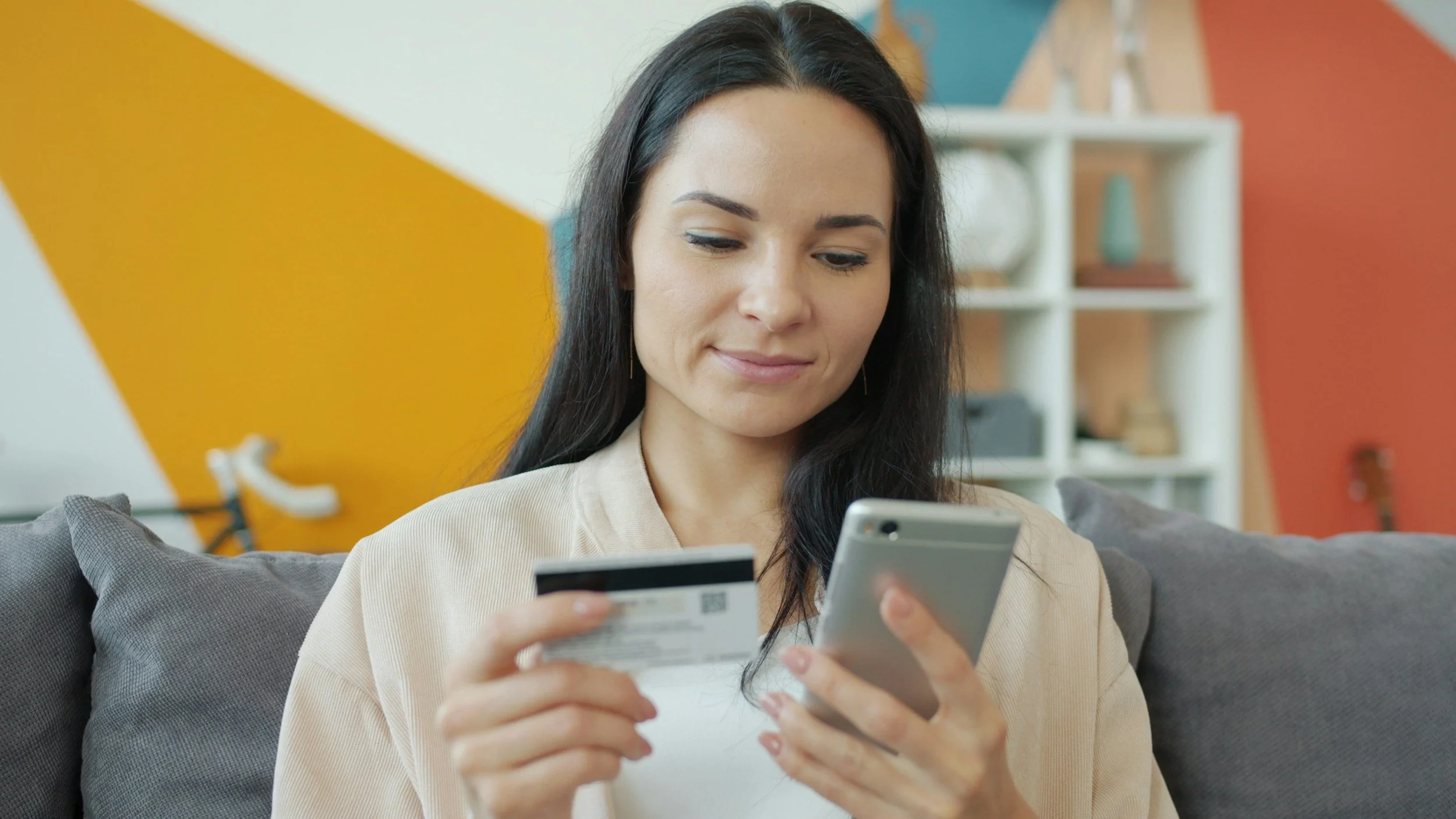 woman inputting financial information into phone