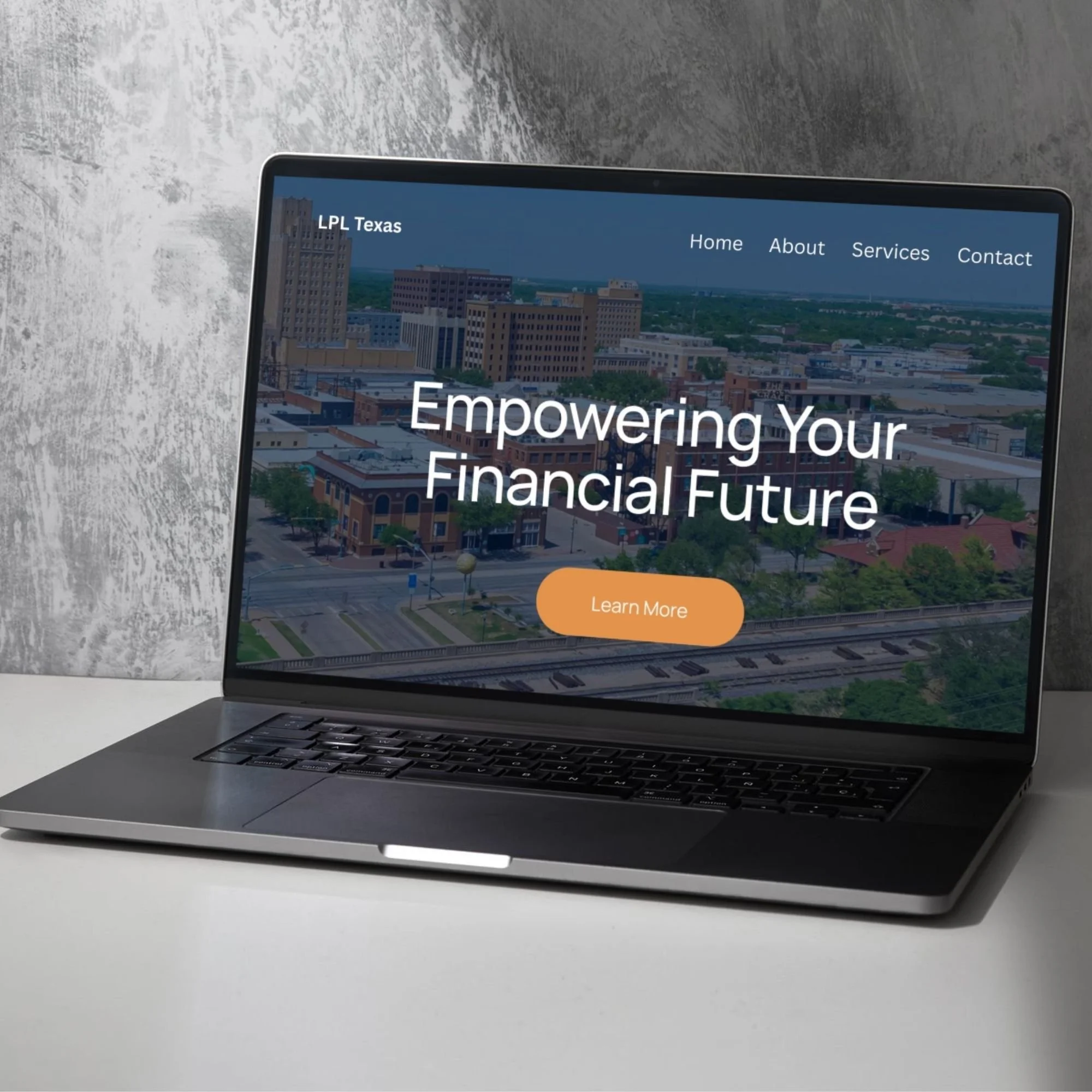 Laptop computer on a white desk displaying a website with the headline "Empowering Your Financial Future" and menu options for Home, About, Services, and Contact, with a cityscape background on the screen.