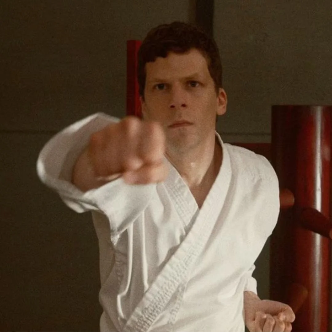 Man in martial arts uniform performing a punch.