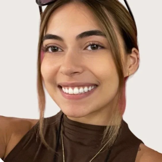 NYC Footy's Jessica Caunedo. Smiling person with glasses on head, brown hair, and a brown top.