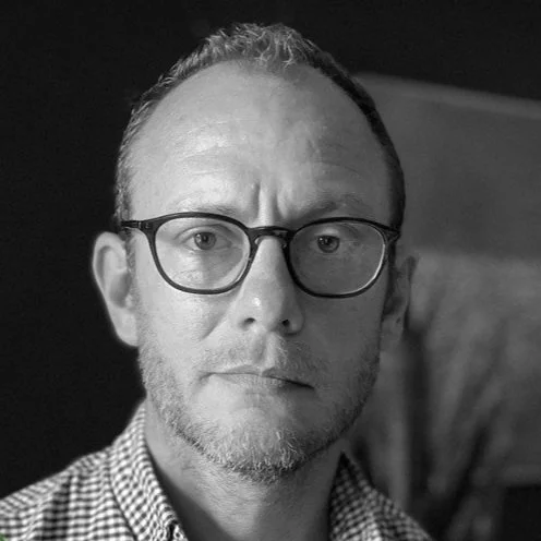 NYC Footy's Andrew Frieband. Black and white portrait of a man wearing glasses