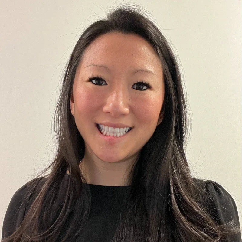 NYC Footy's Amanda Middleton. A person with long dark hair smiling against a plain background.