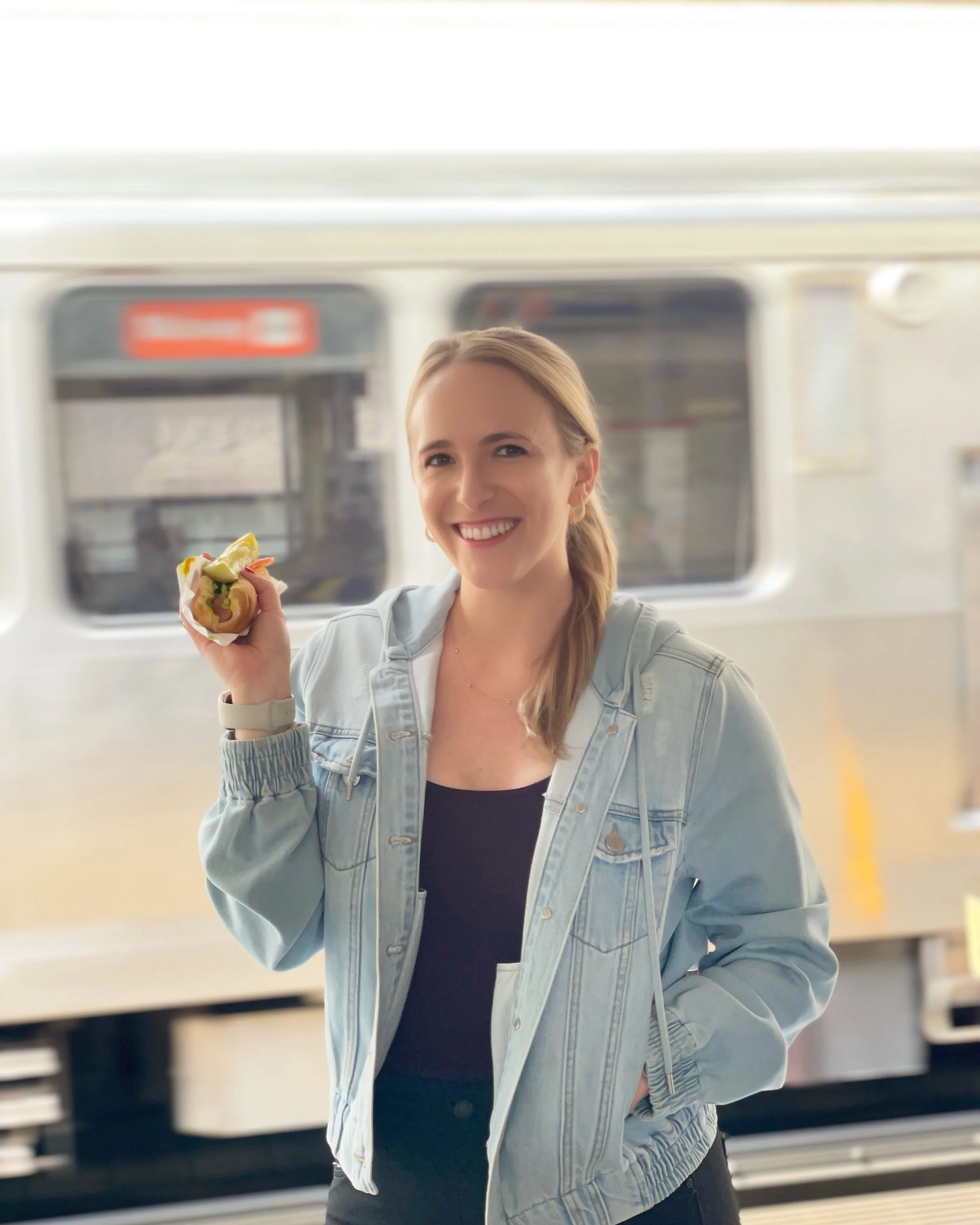 Molly Jones holding a Chicago hot dog
