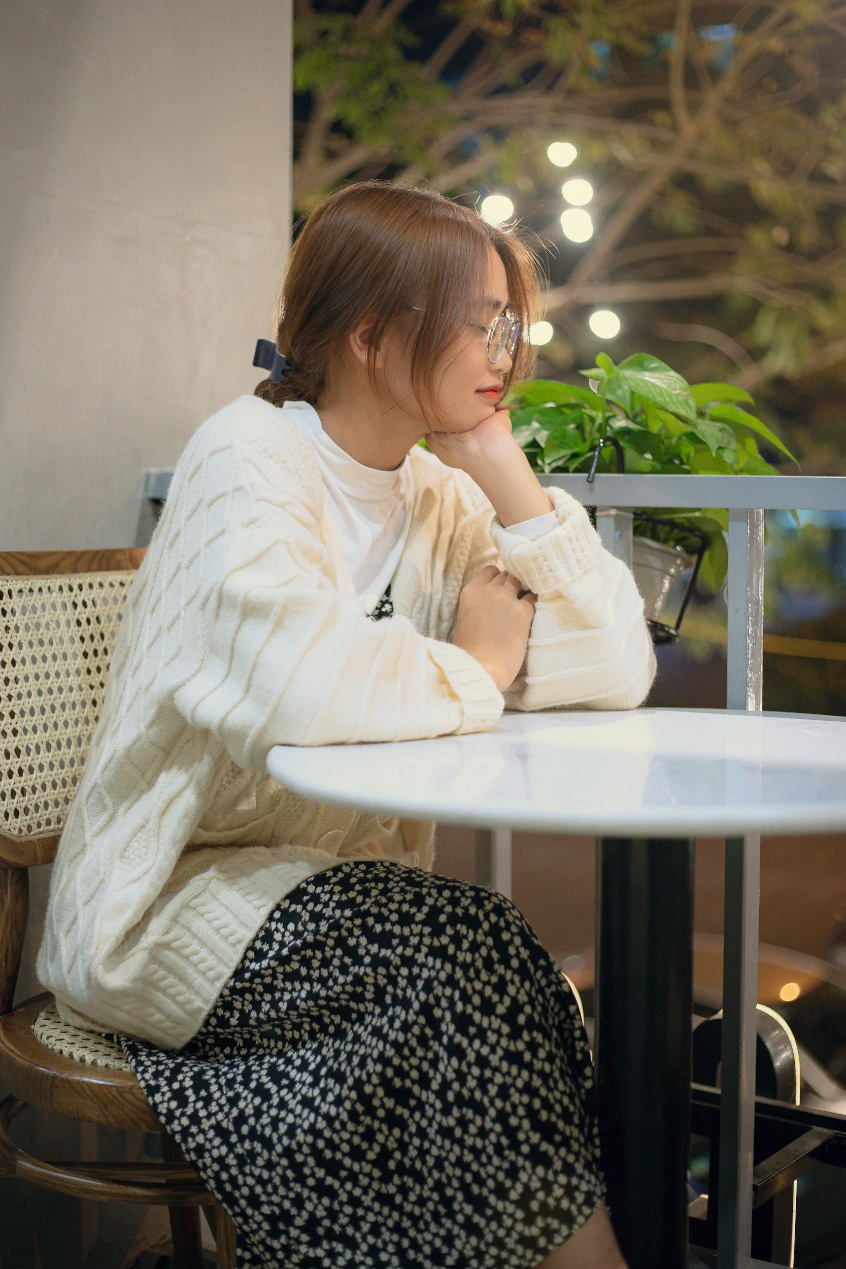 Woman sitting alone at table waiting for her friends