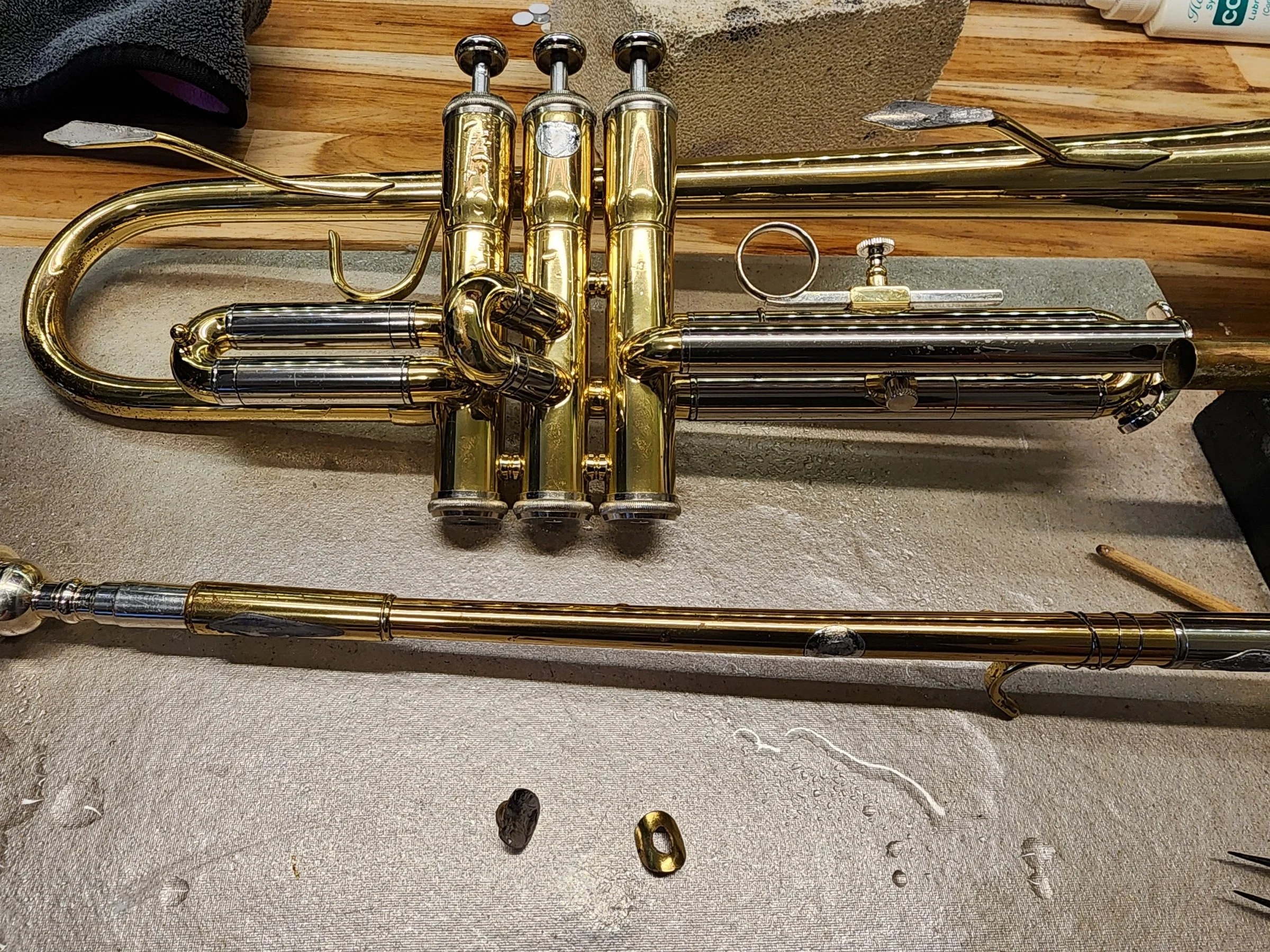 Broken off trumpet lead pipe with stuck mouthpiece.