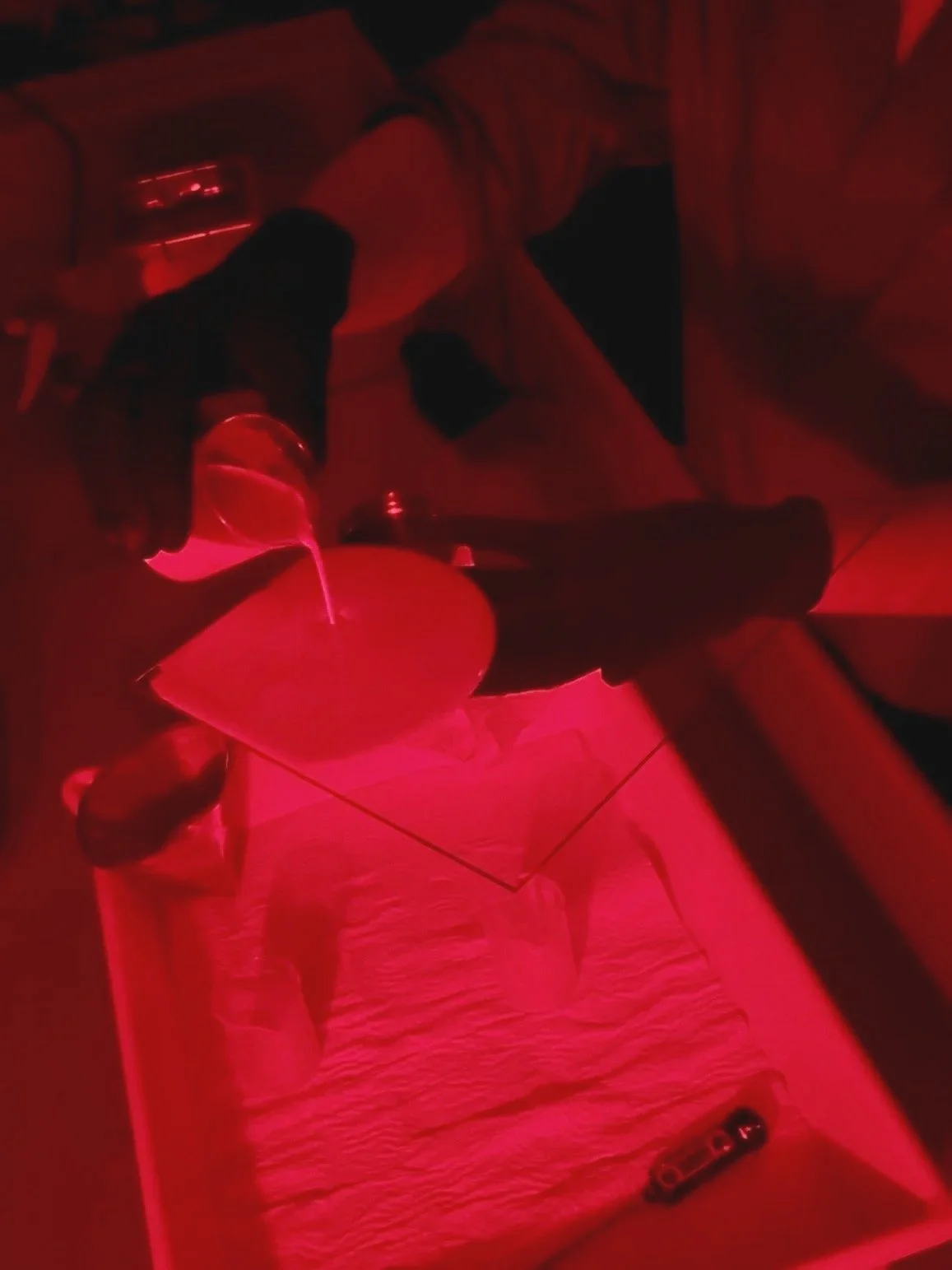 pouring silver gelatin emulsion onto a glass plate.
