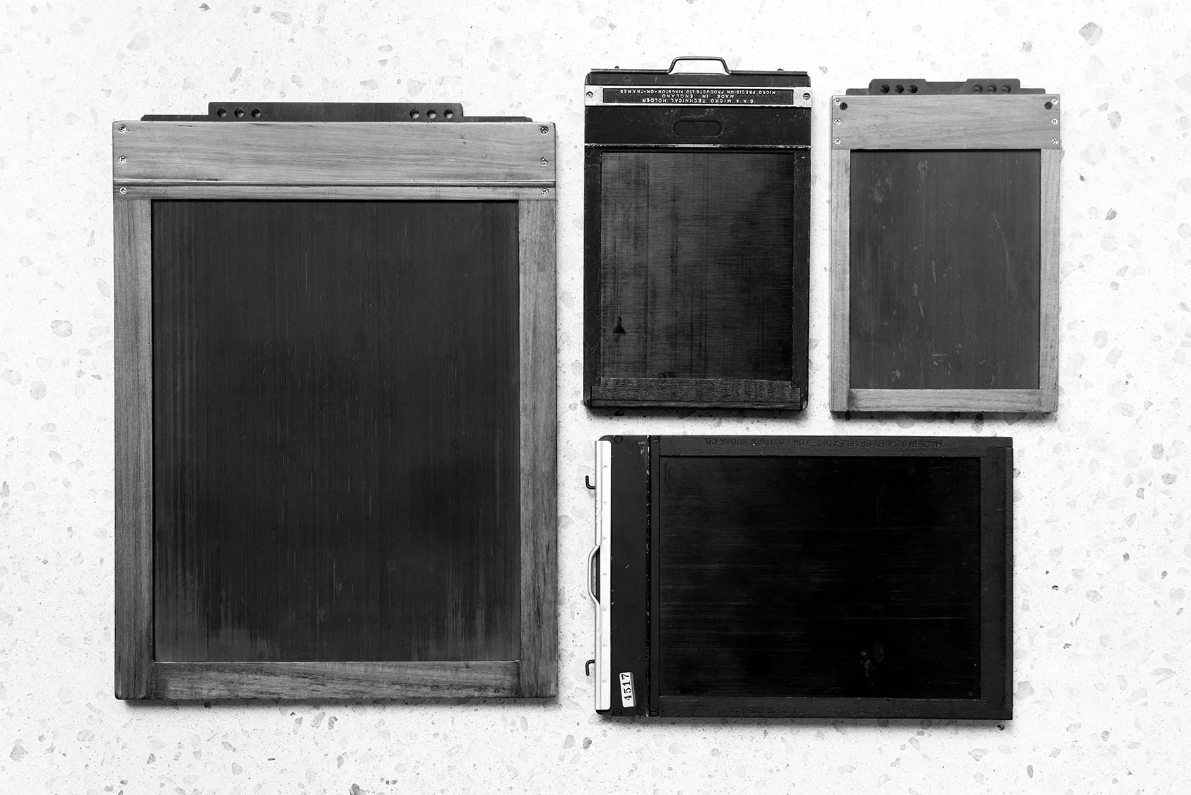 Four photographic plate holders.