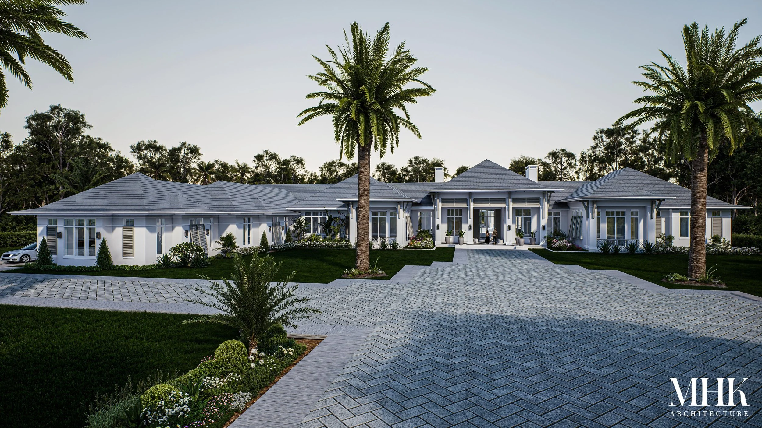 Luxury white house with a large driveway, surrounded by palm trees and well-maintained landscaping.